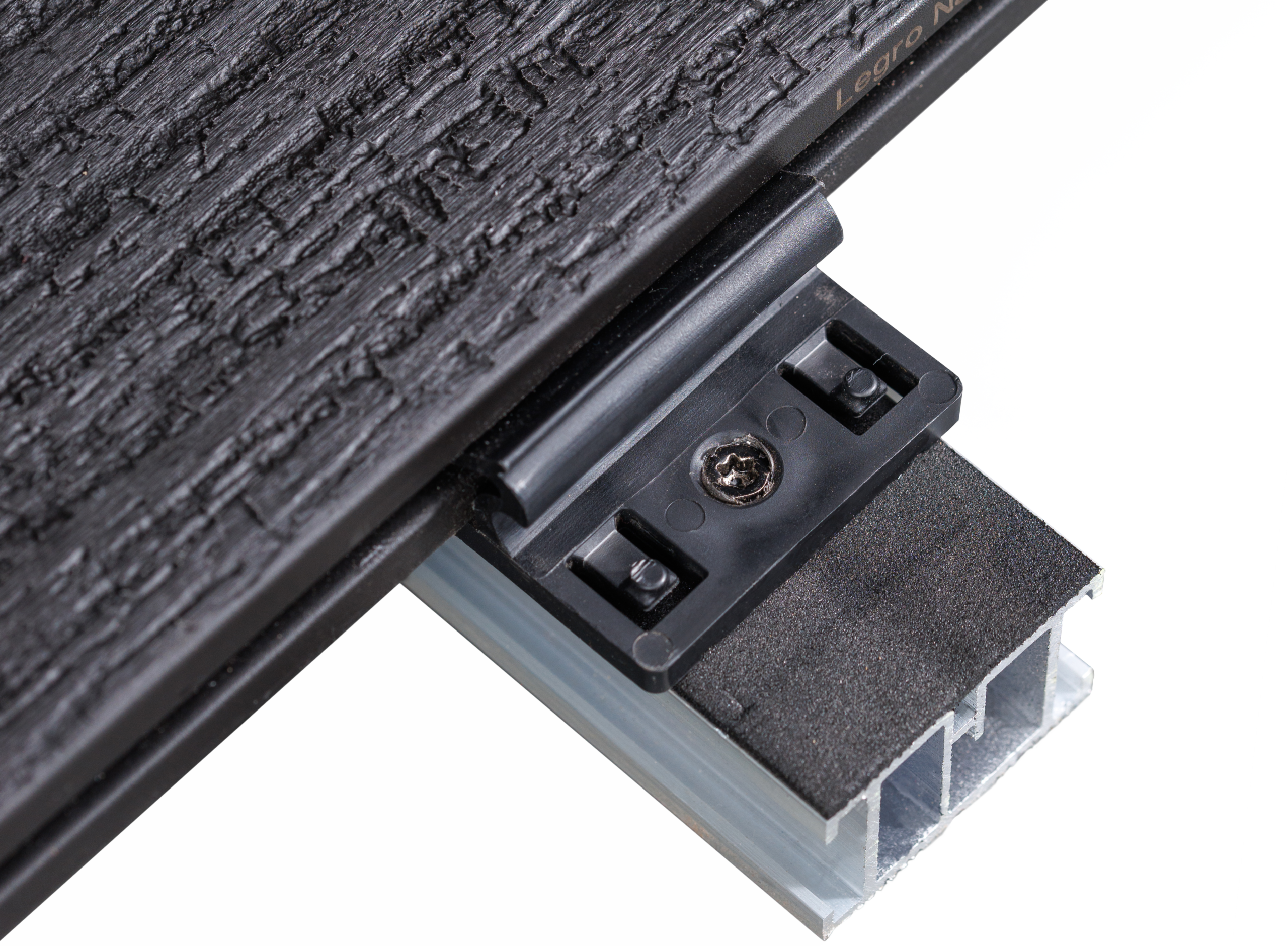 Close-up of a black textured stepping surface with a metal rail and a small screw clamp.