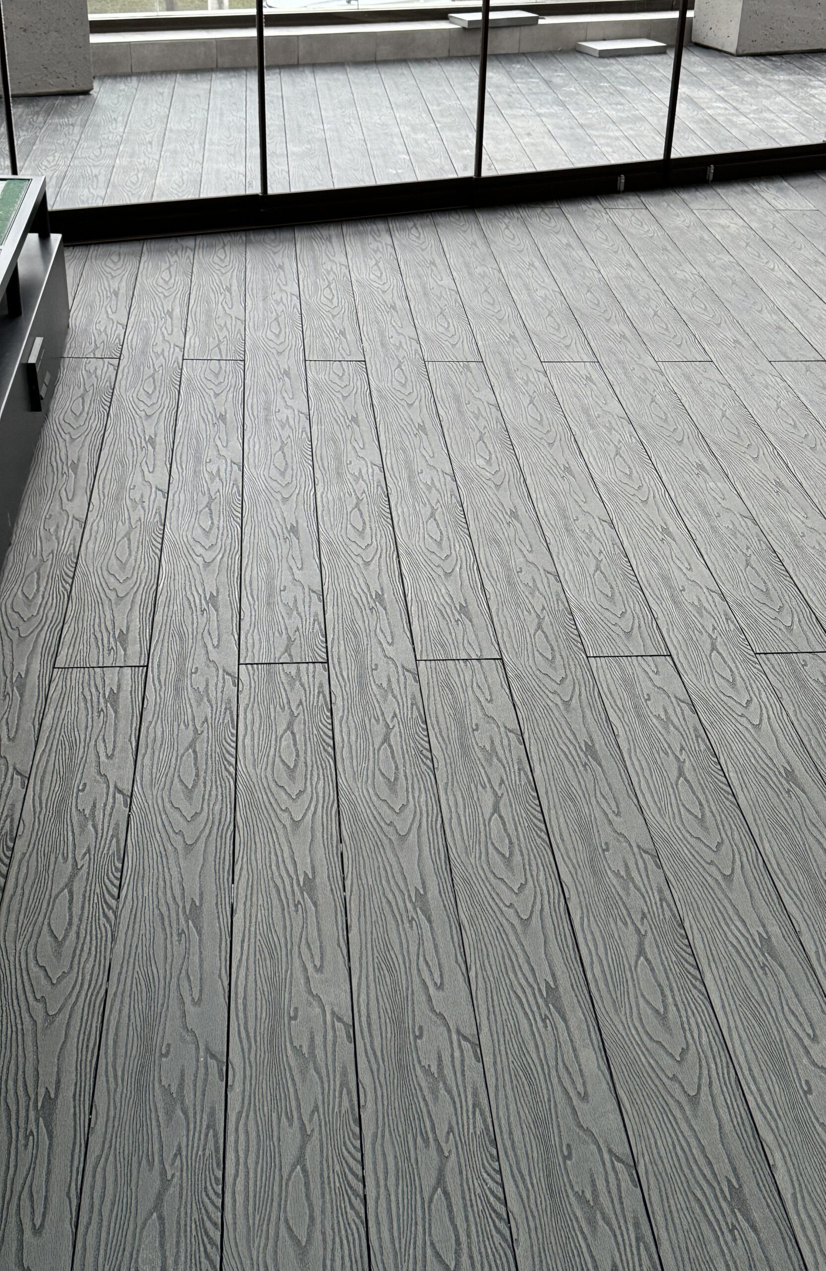 Bruggan Elegant Anthracite decking with realistic wood grain pattern in a modern terrace