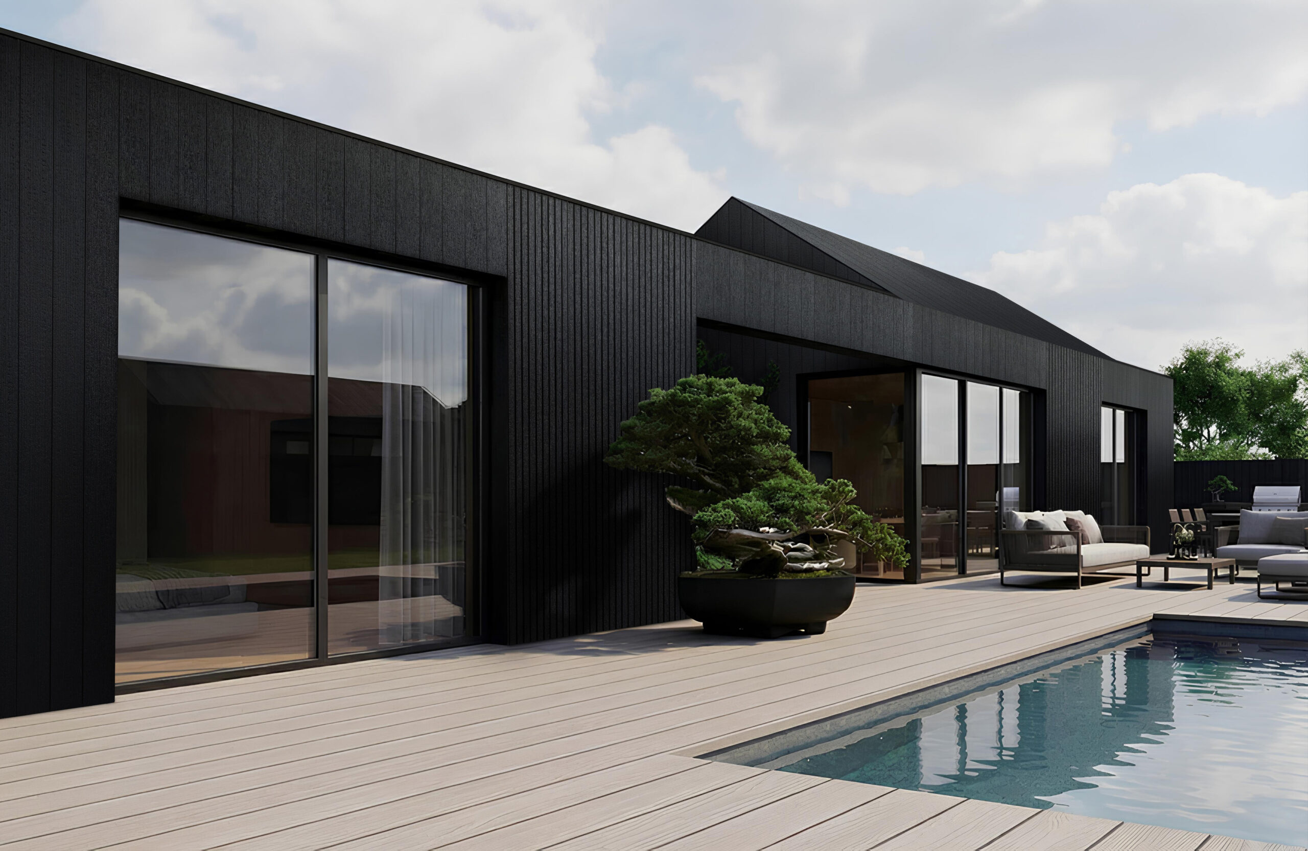 Modern black contemporary home exterior with large glass doors, wooden deck, pool, and outdoor seating under a cloudy sky