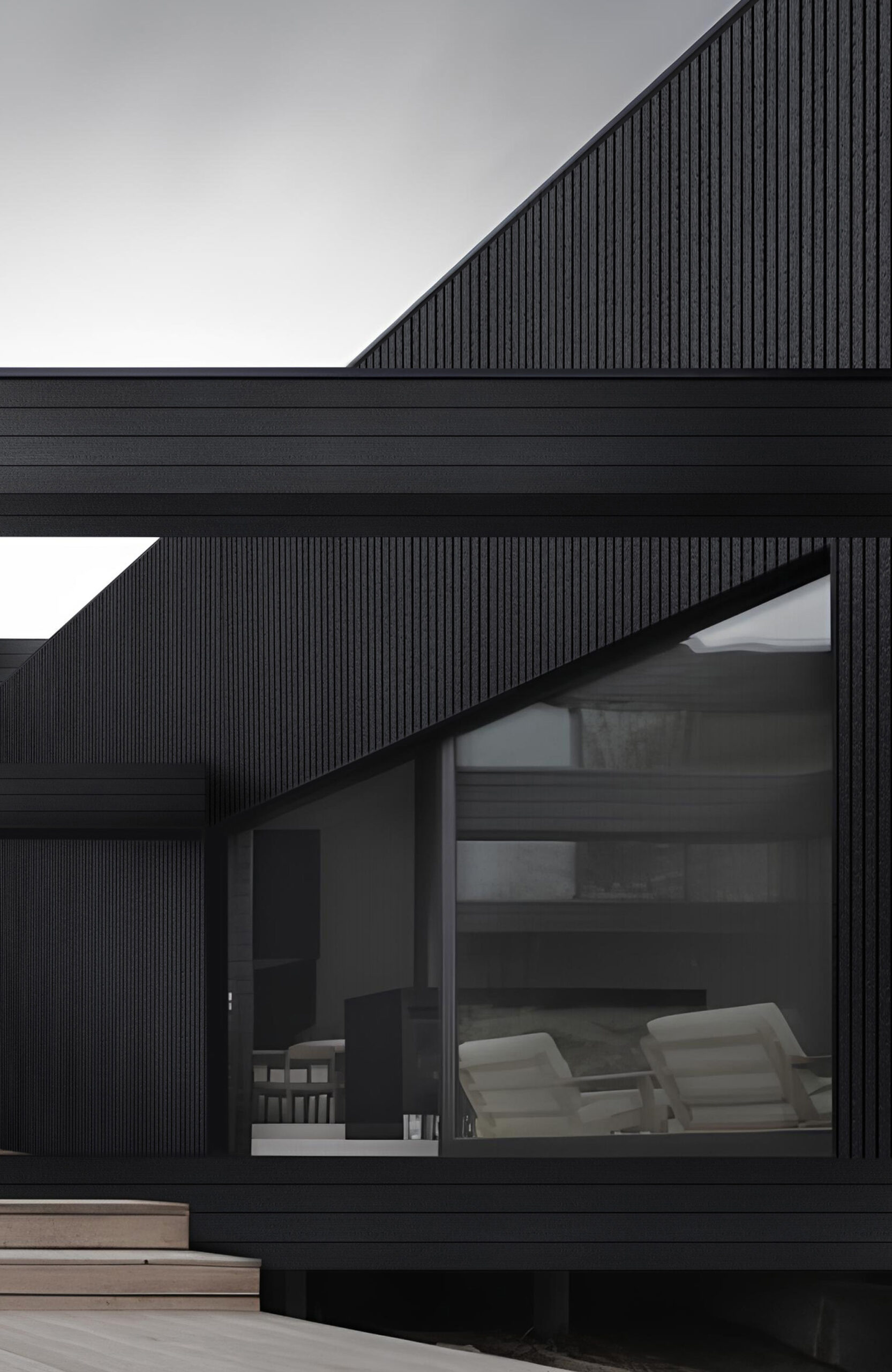 Modern black building facade with vertical slatted panels and large glass windows at the entrance area.