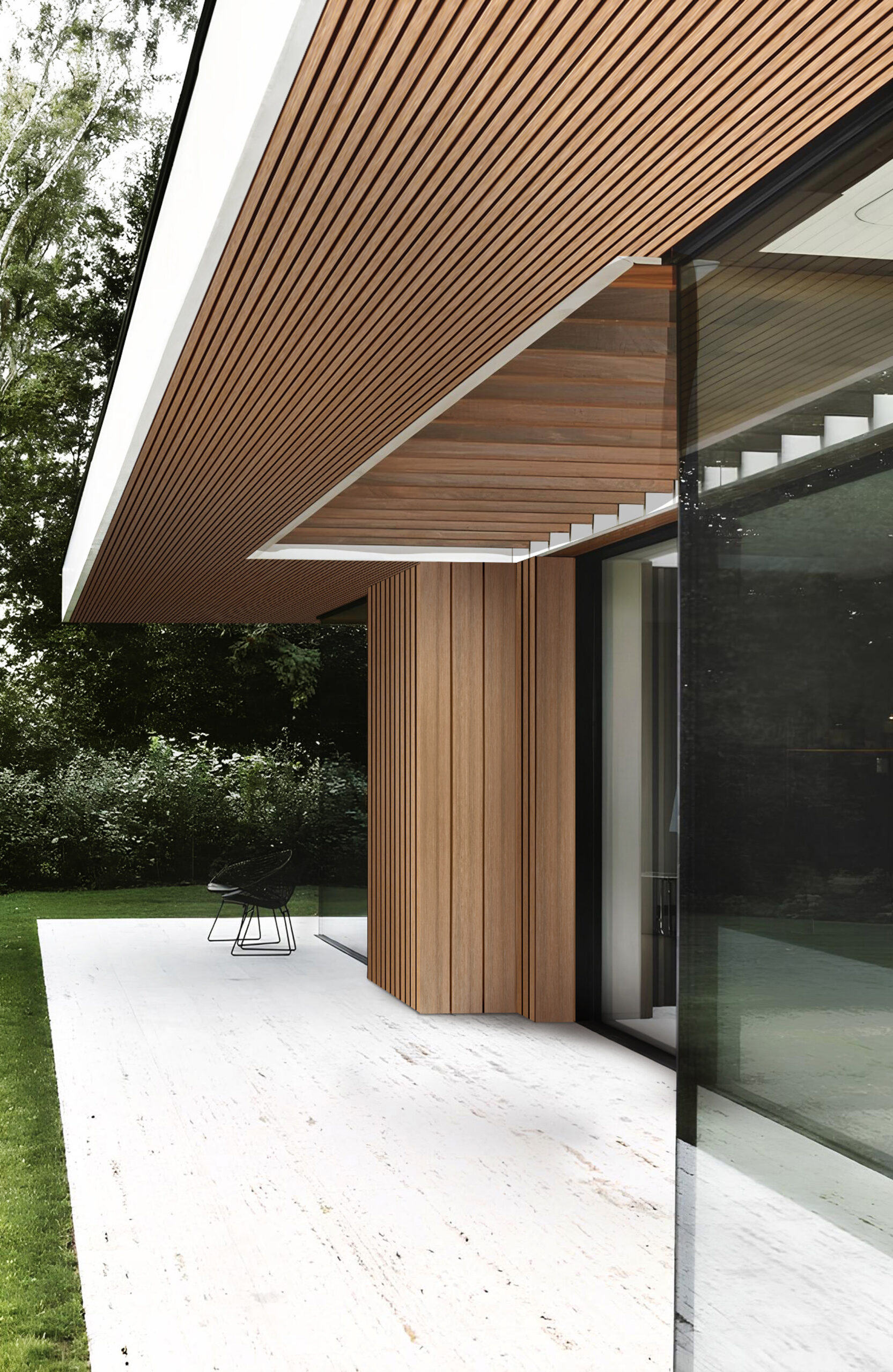 Modern house exterior featuring a wood-slatted overhang, vertical wooden posts, and a glass wall; white patio and green lawn in the background.