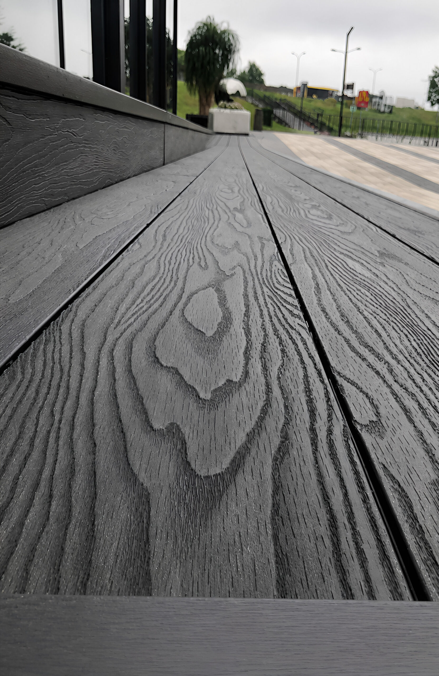 Close-up of Bruggan Elegant Anthracite composite decking with realistic wood grain texture