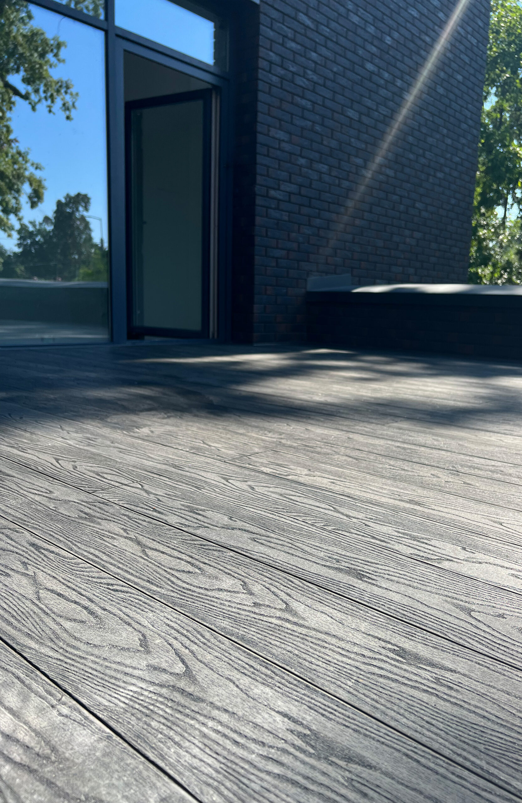 Close-up of anthracite composite decking with realistic wood grain surface