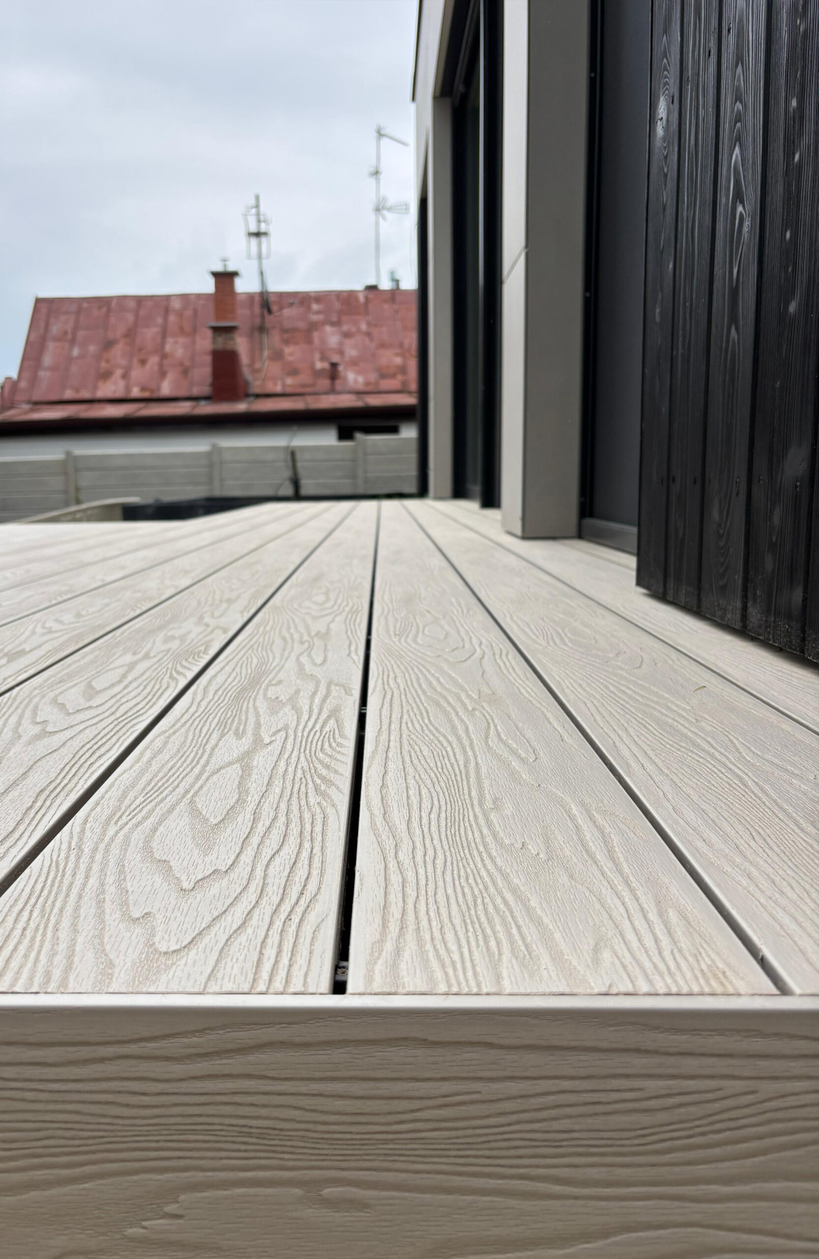 Bruggan Elegant Cream Latte composite decking with natural wood grain texture on a modern terrace