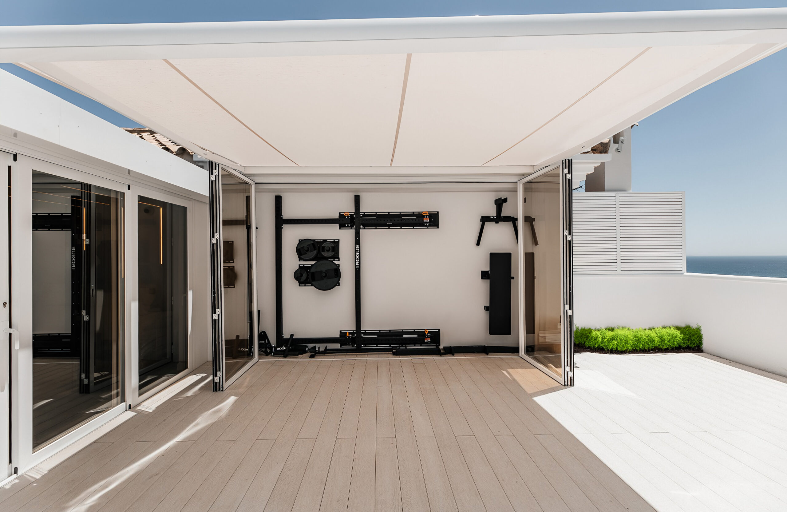 Bruggan Elegant Cream Latte decking on a modern rooftop terrace with a covered outdoor gym