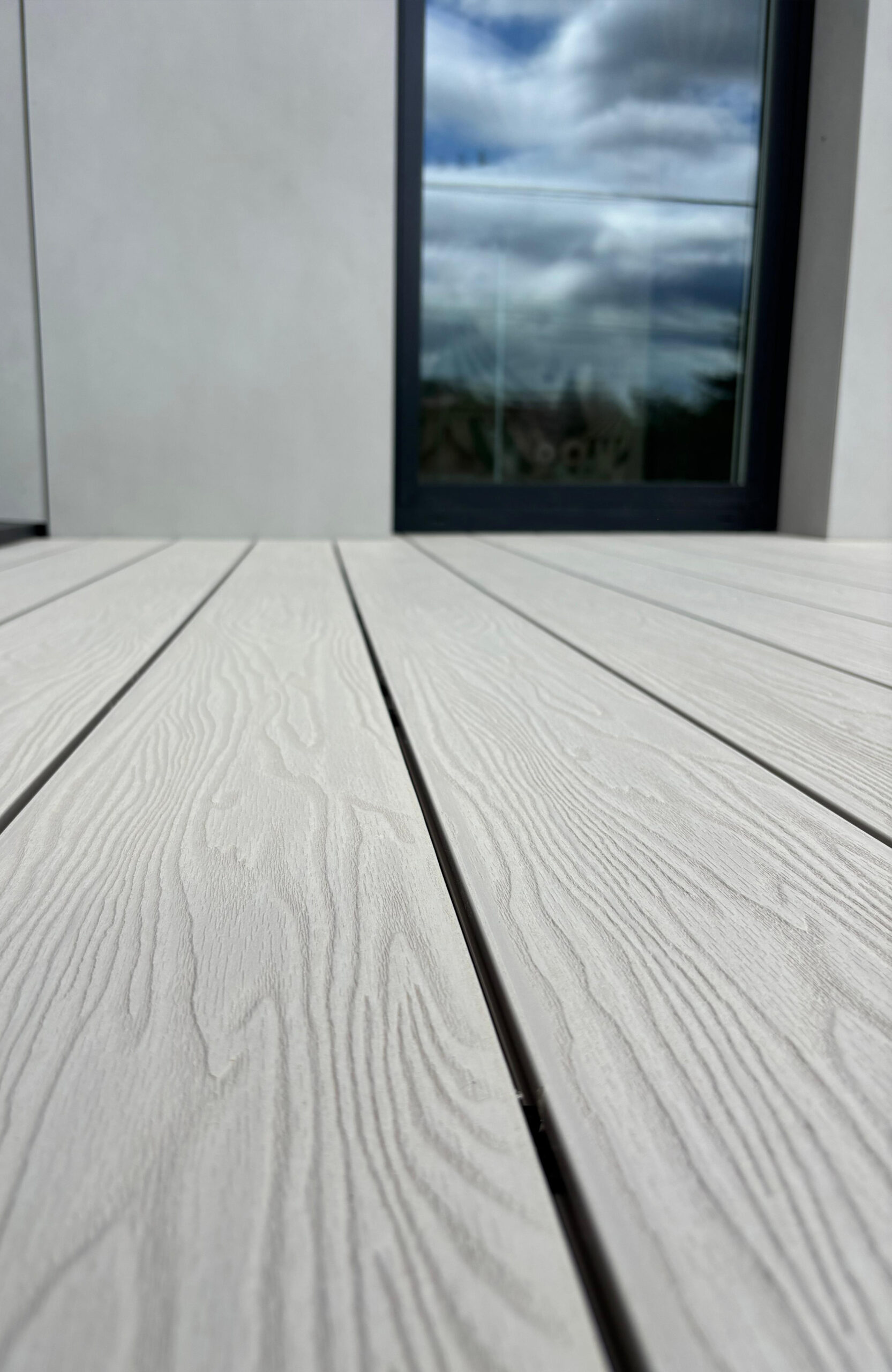 Close-up of Bruggan Elegant Cream Latte decking showing realistic wood grain texture