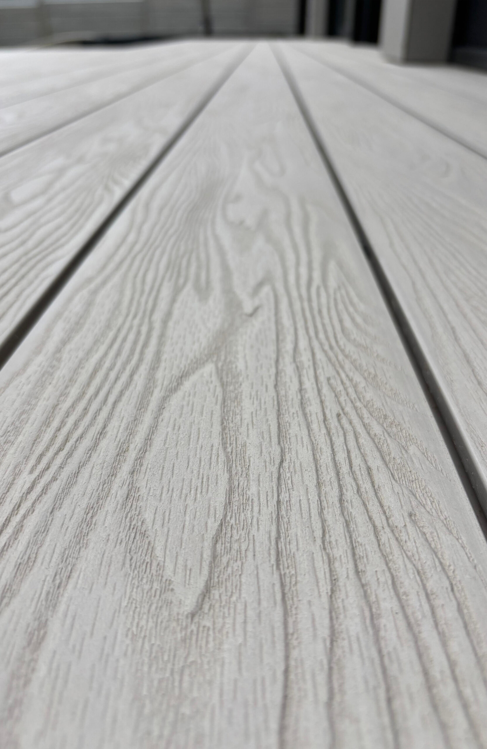 Detailed close-up of Bruggan Elegant Cream Latte composite decking boards
