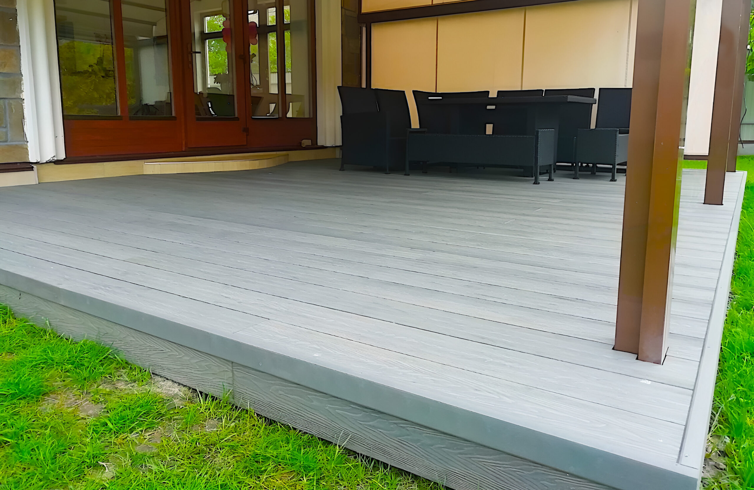 Covered patio with Bruggan Elegant Graphite composite decking and outdoor dining area