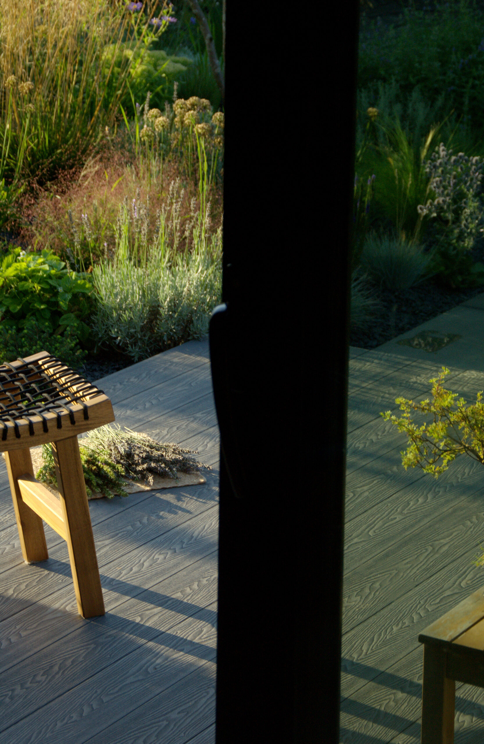 Bruggan Elegant Graphite decking in a modern garden terrace with natural greenery