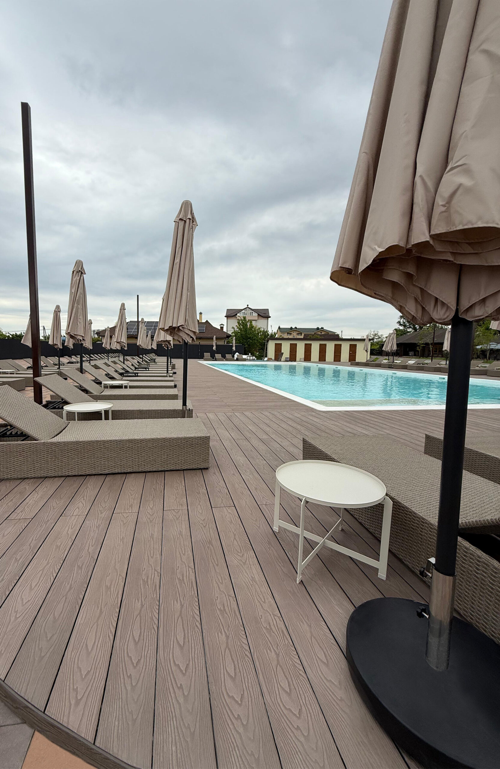 Bruggan Elegant Wine Brown composite decking around the swimming pool at Bilohorodski Lazni, Kyiv Oblast, Ukraine