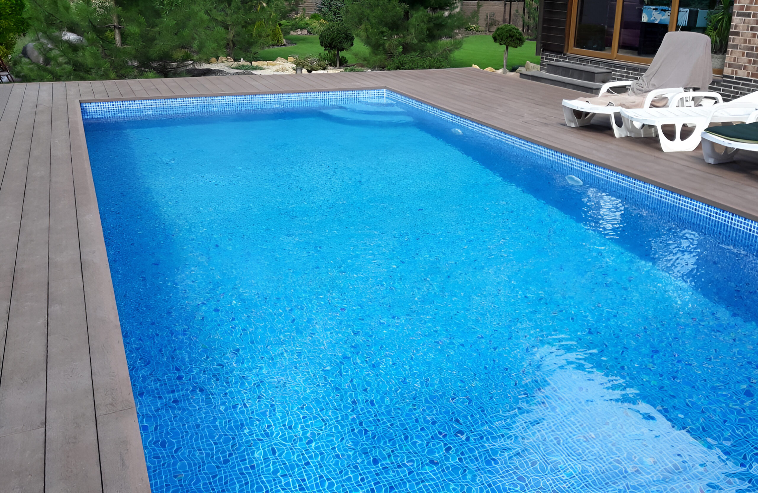 Bruggan Elegant Wine Brown composite decking surrounding a private outdoor swimming pool with a landscaped garden
