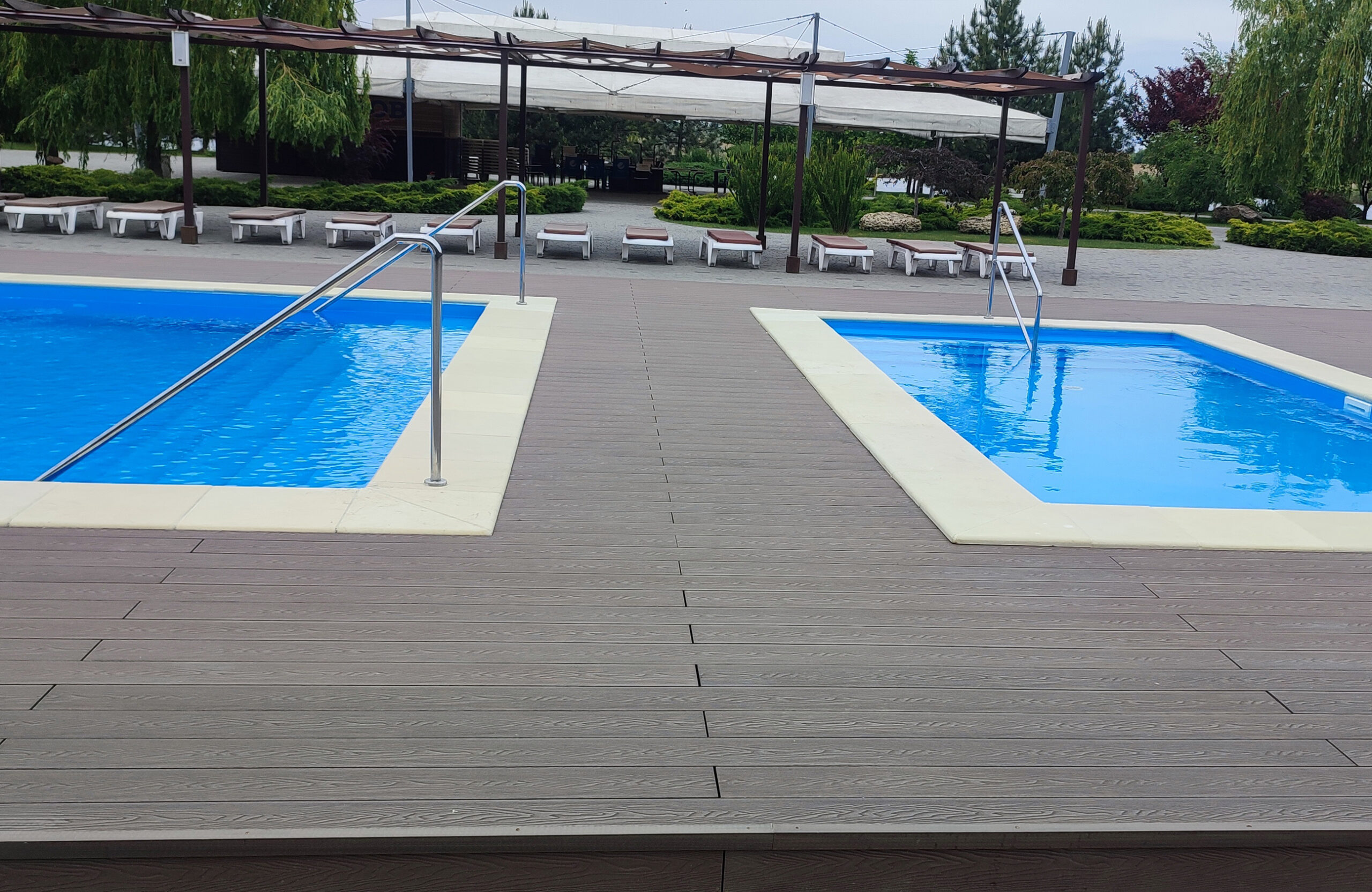 Outdoor pool terrace with Bruggan Elegant Wine Brown composite decking at Ostrov River Club