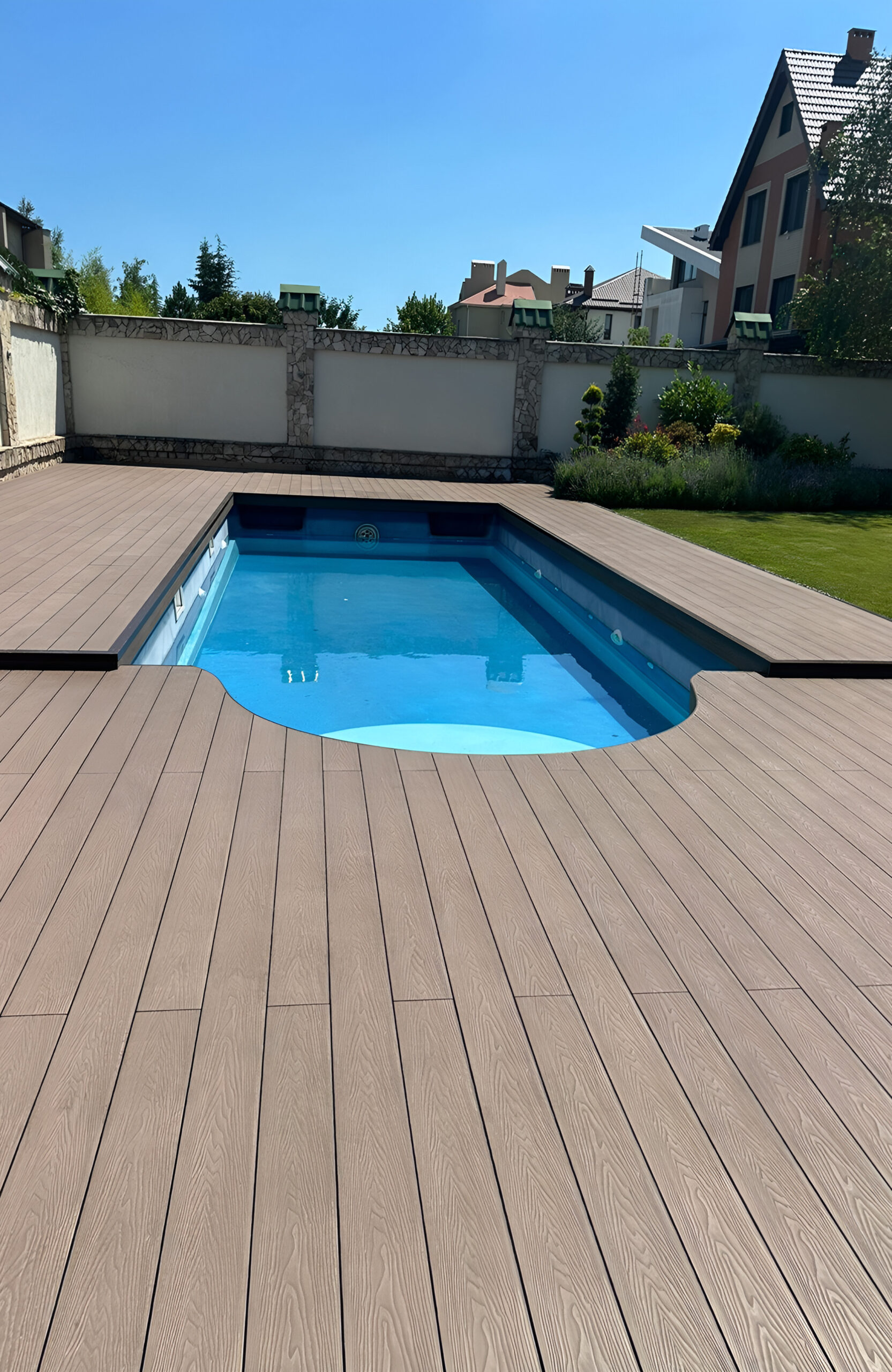 Bruggan Elegant Wine Brown composite decking surrounding a private outdoor swimming pool and landscaped garden