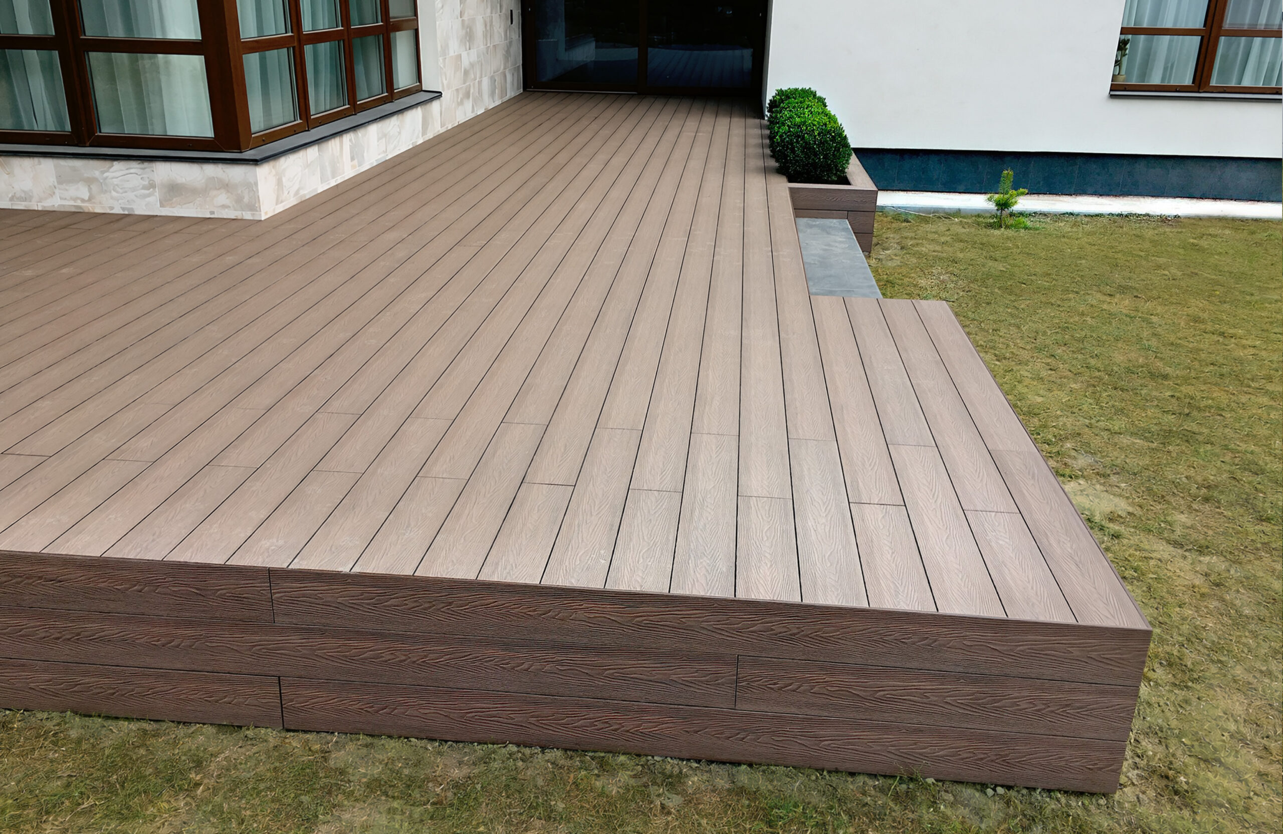 Raised terrace finished with Bruggan Elegant Wine Brown composite decking and vertical fascia boards