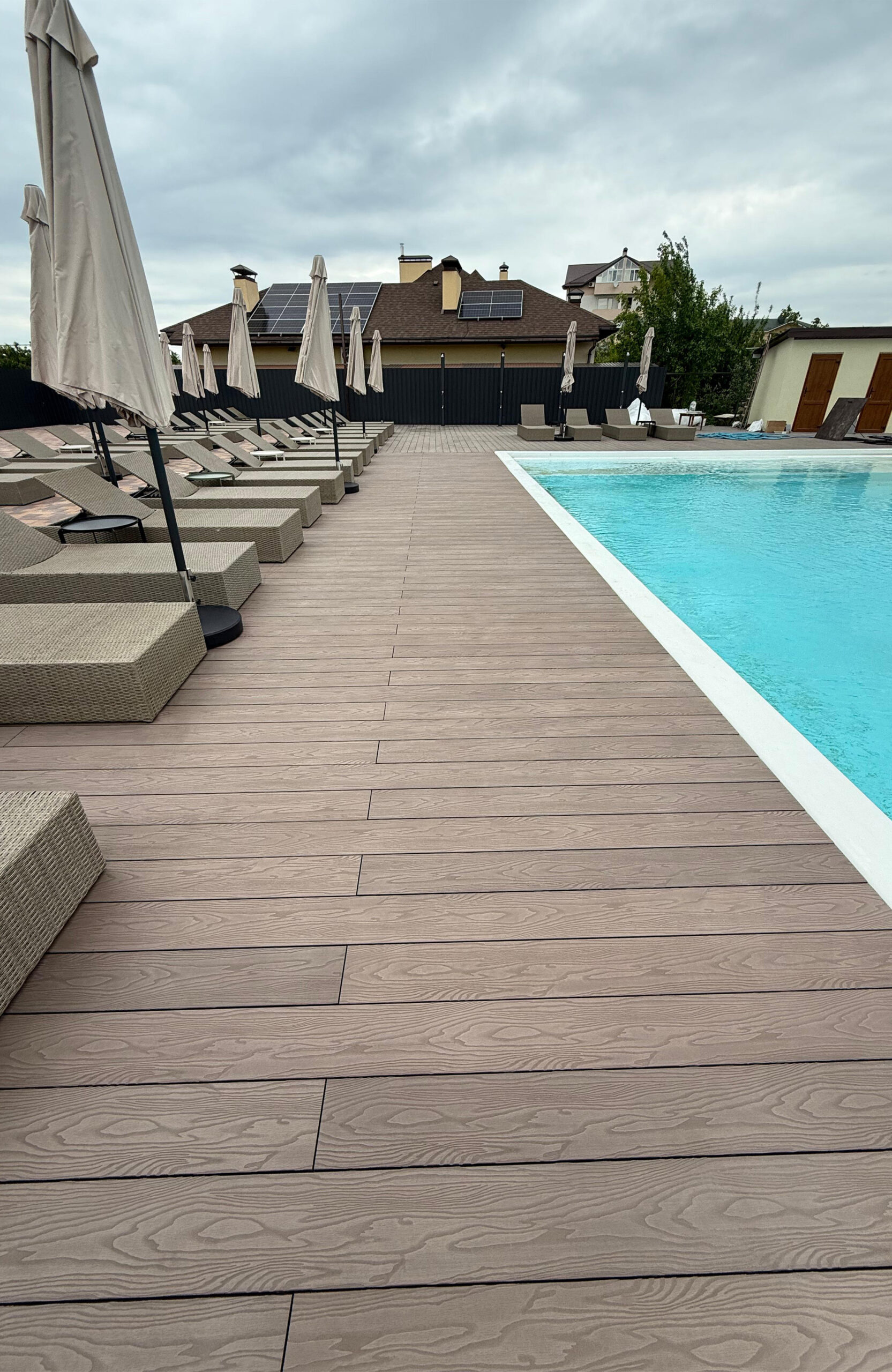 Spacious poolside terrace finished with Bruggan Elegant Wine Brown composite decking in Kyiv Oblast, Ukraine