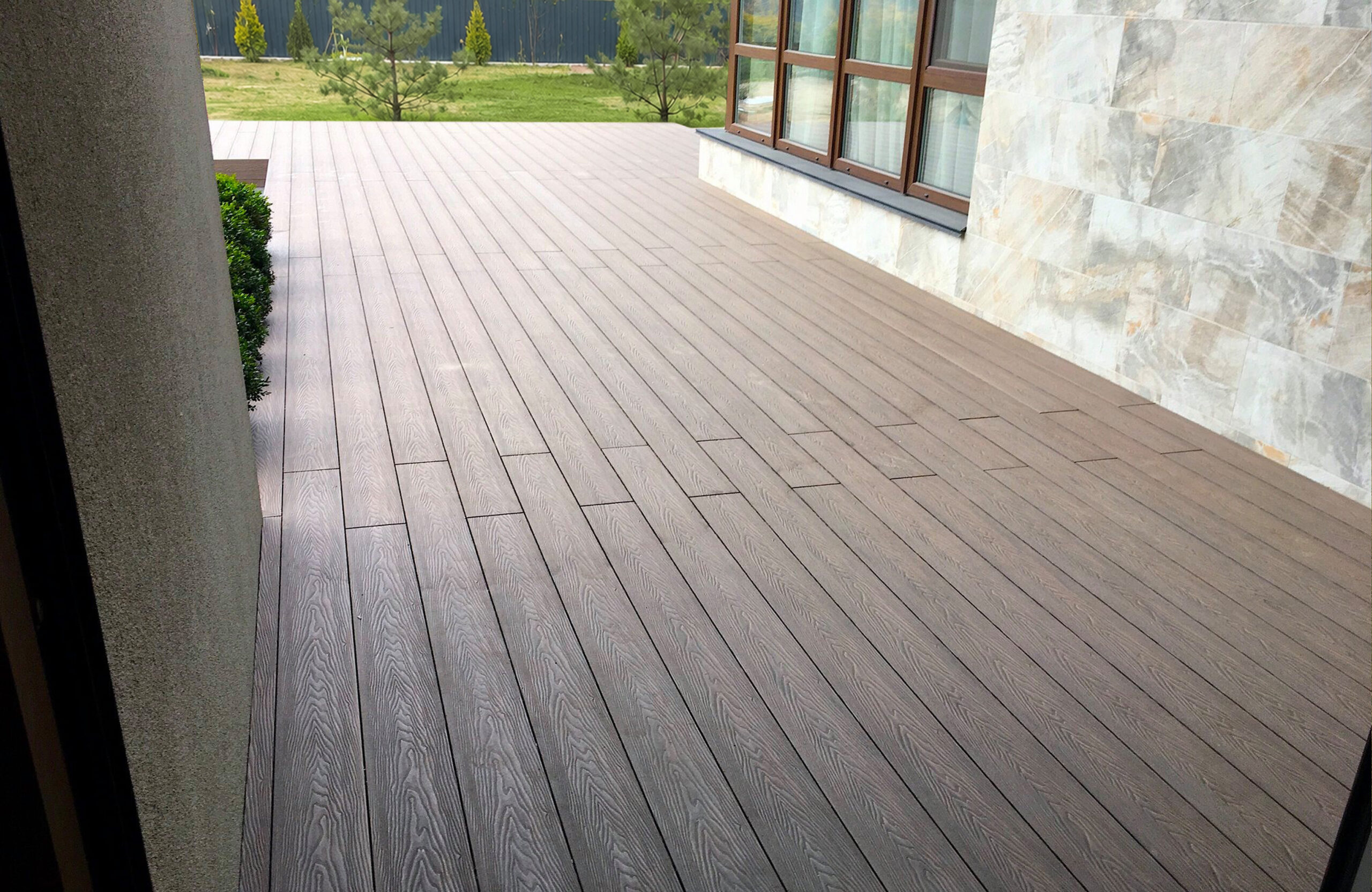 Raised terrace finished with Bruggan Elegant Wine Brown composite decking and vertical fascia boards