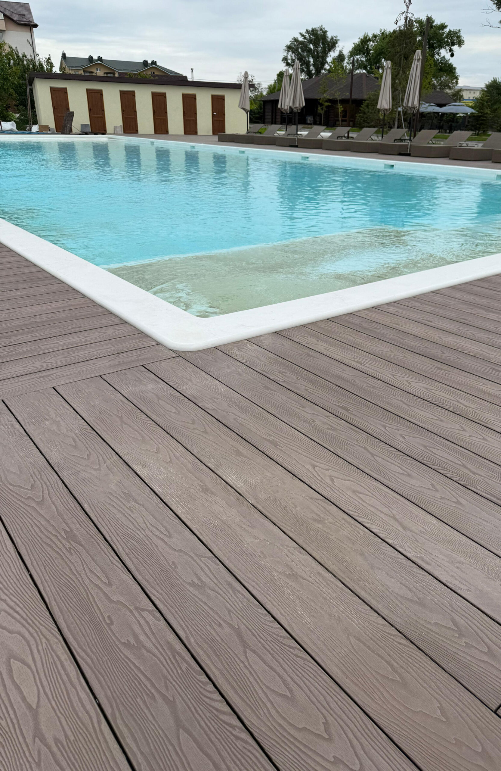 Bruggan Elegant Wine Brown decking installed around an outdoor swimming pool at Bilohorodski Lazni