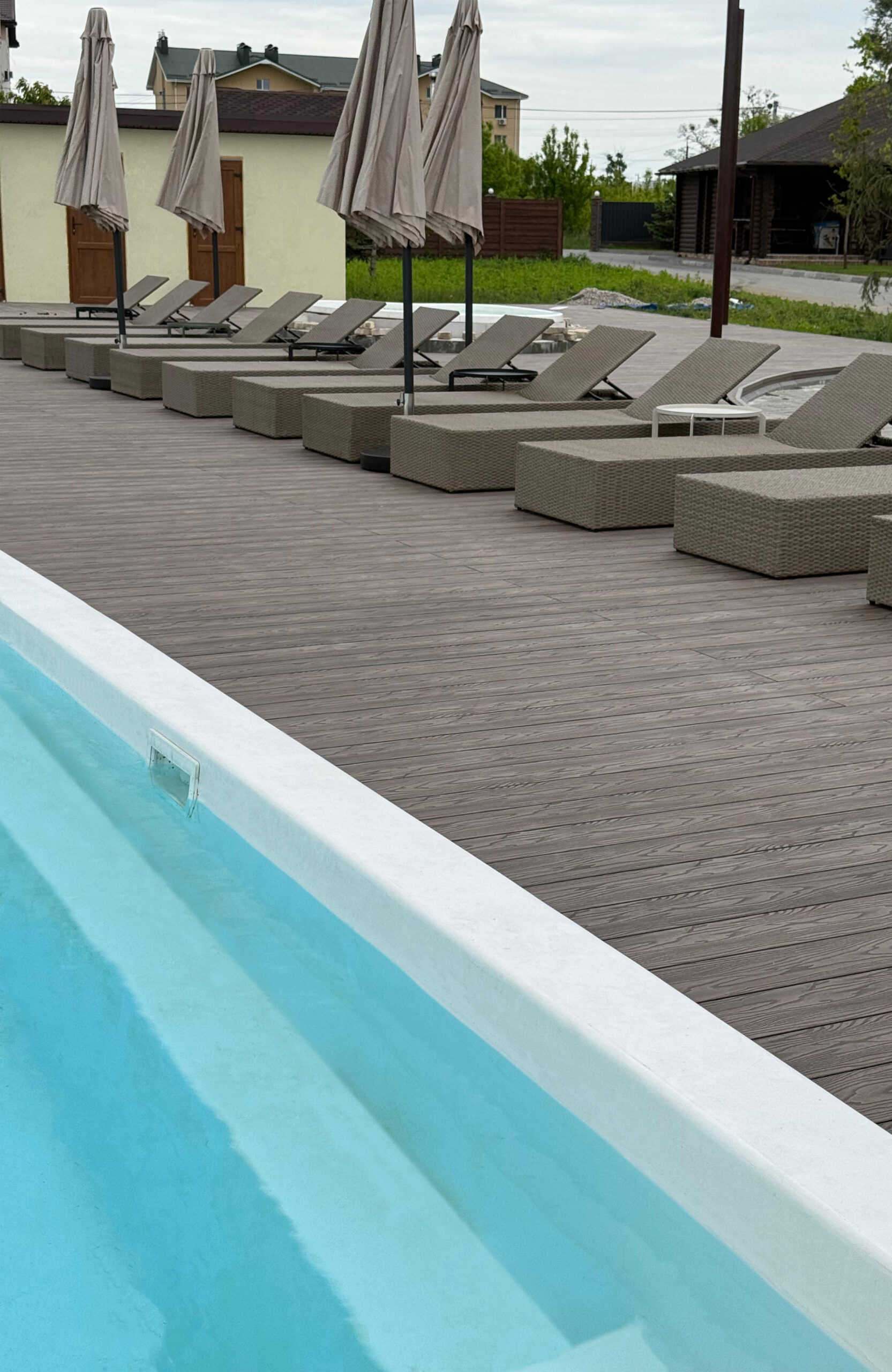 Swimming pool and relaxation area with Bruggan Elegant Wine Brown composite terrace decking in Ukraine