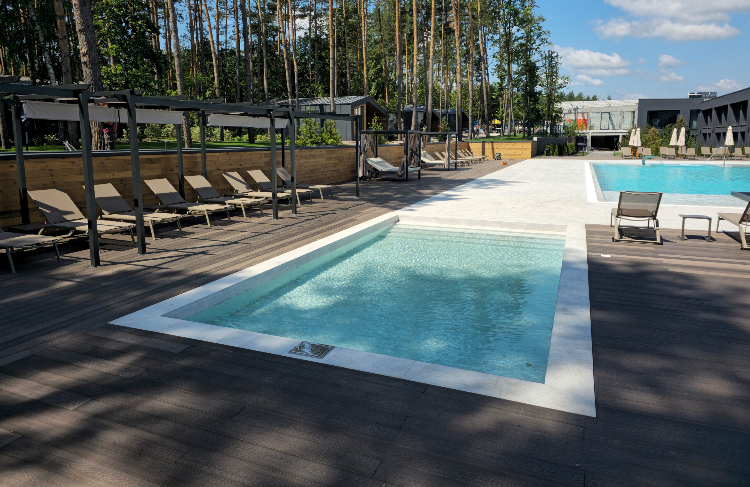 Poolside recreation area featuring Bruggan Elegant Wine Brown terrace decking at Riverwood Relax Park in Cherkasy Oblast, Ukraine