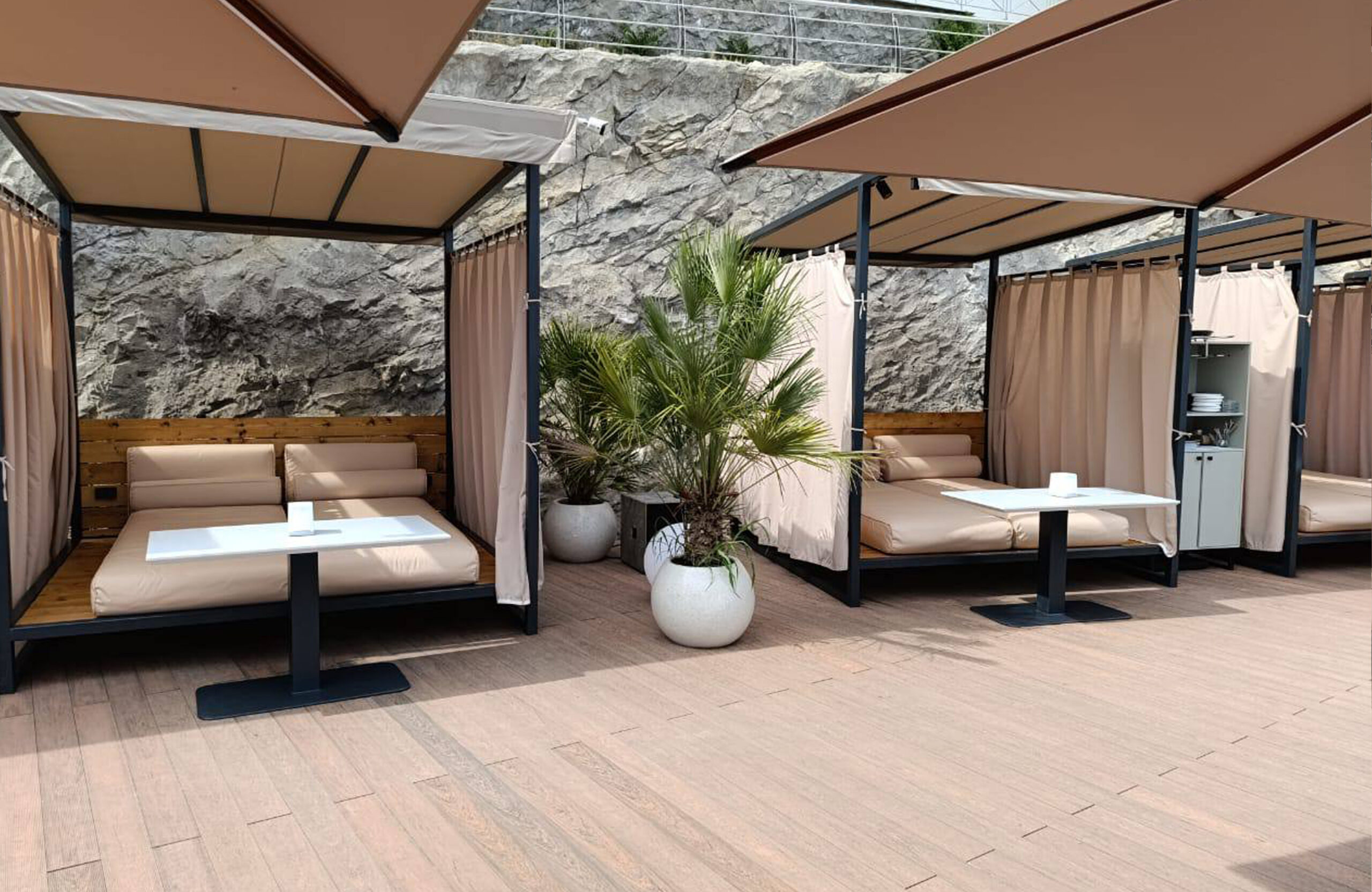 Bruggan Multicolor Cedar composite decking in a luxury outdoor lounge area with private cabanas