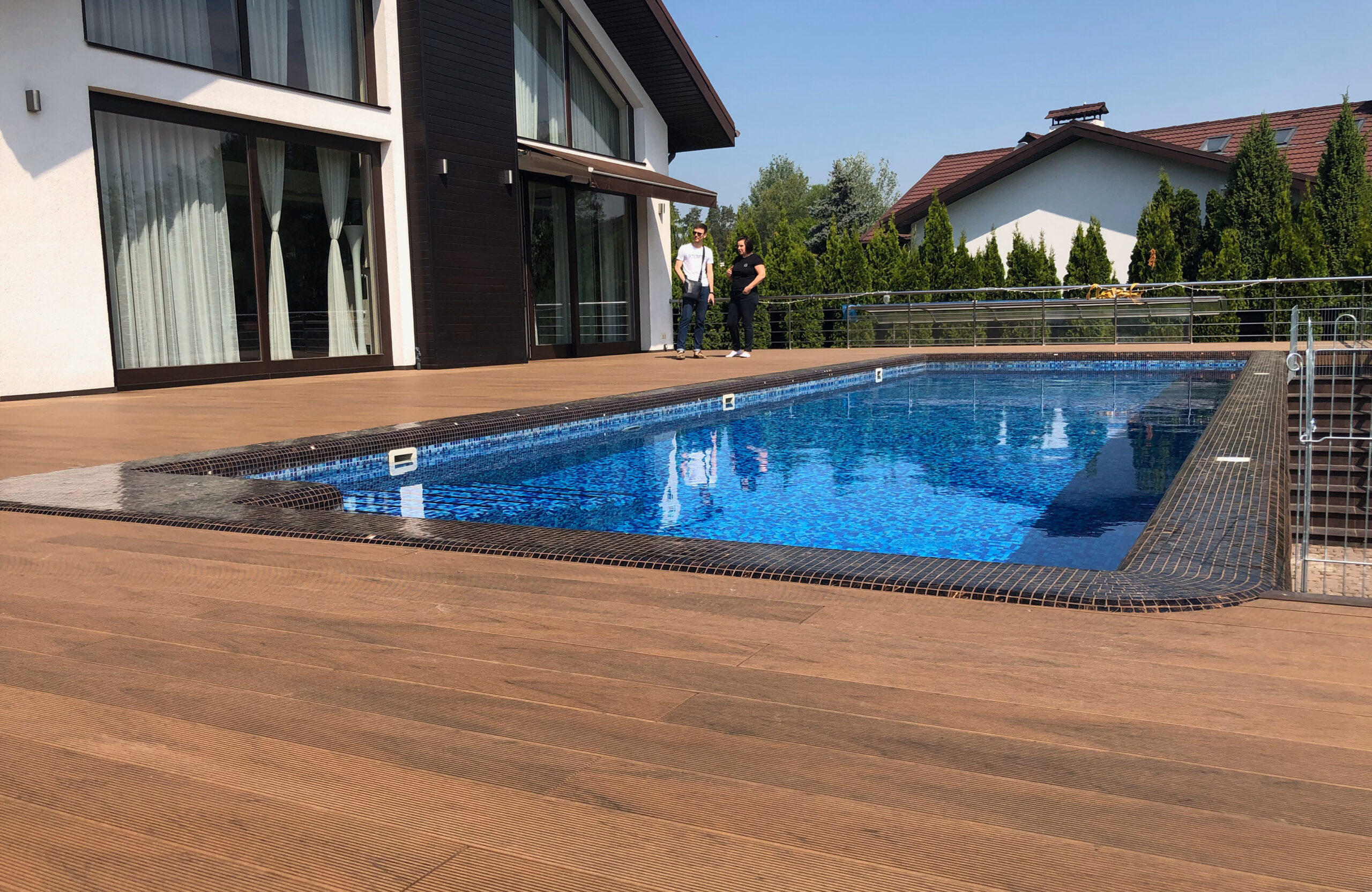 Bruggan Multicolor Cedar composite decking around a private outdoor swimming pool