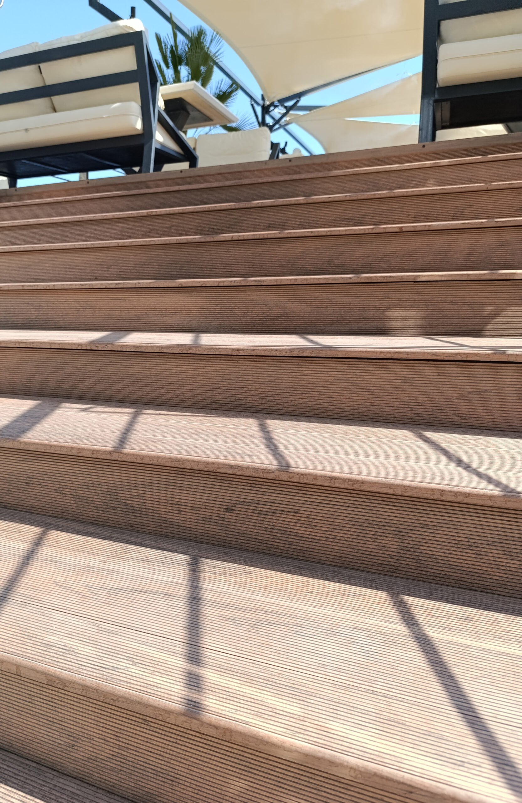 Outdoor stairs finished with Bruggan Multicolor Cedar composite decking at a seaside resort