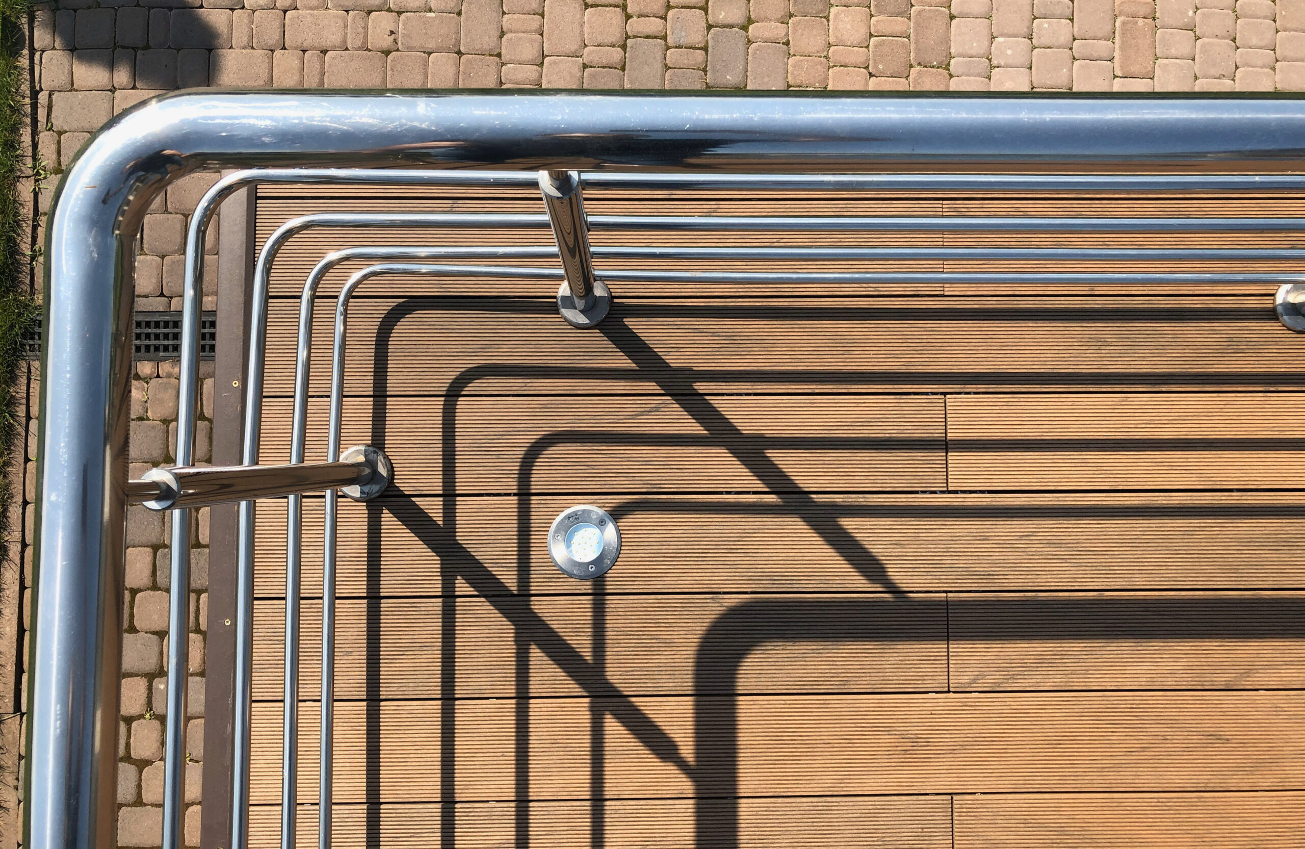 Bruggan Multicolor Cedar composite decking around a private outdoor swimming pool