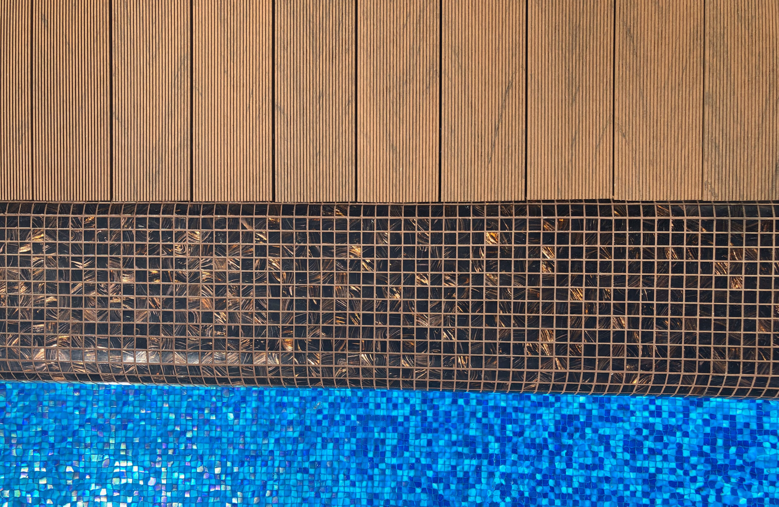 Bruggan Multicolor Cedar composite decking around a private outdoor swimming pool