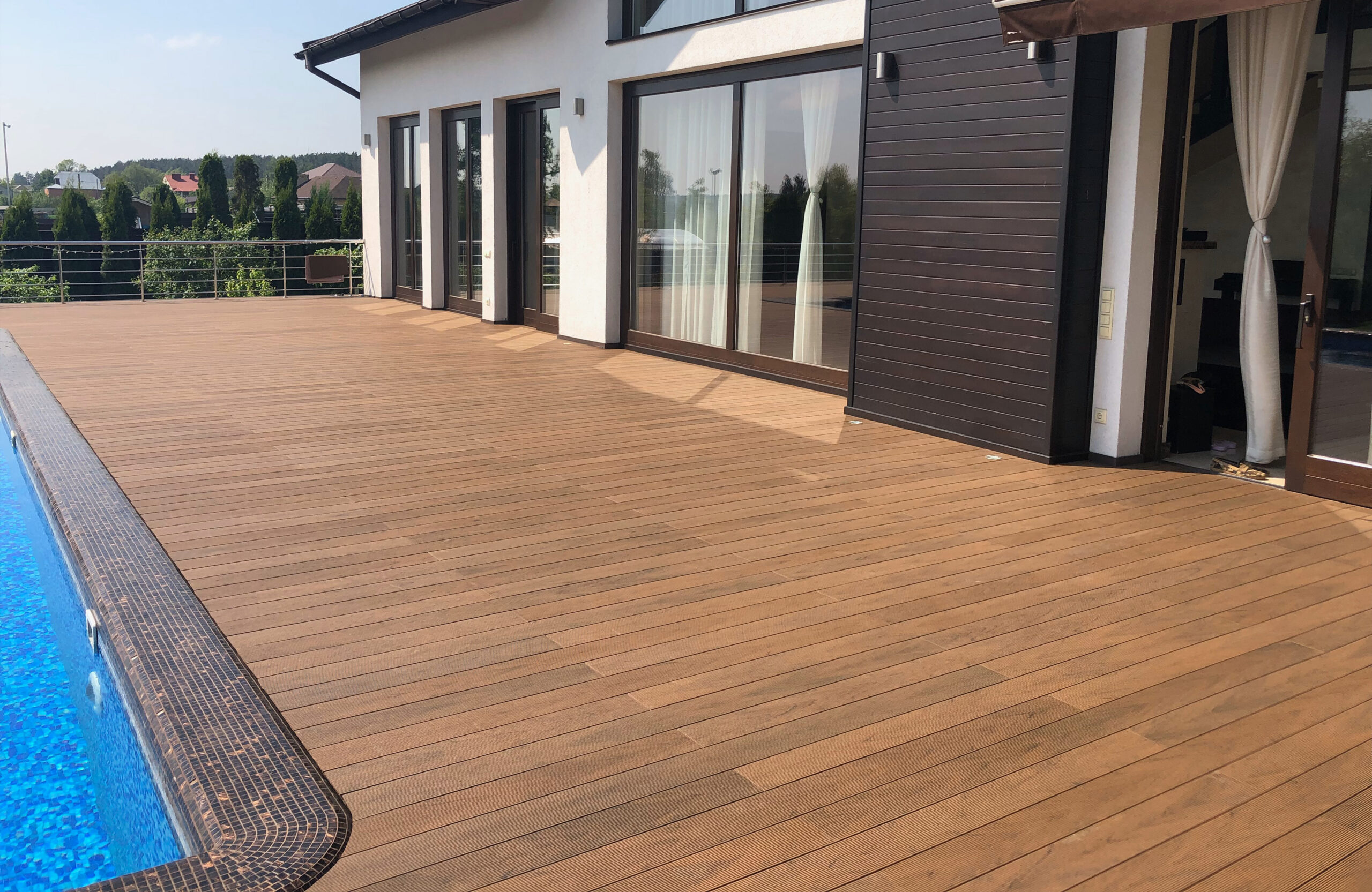 Bruggan Multicolor Cedar composite decking around a private outdoor swimming pool