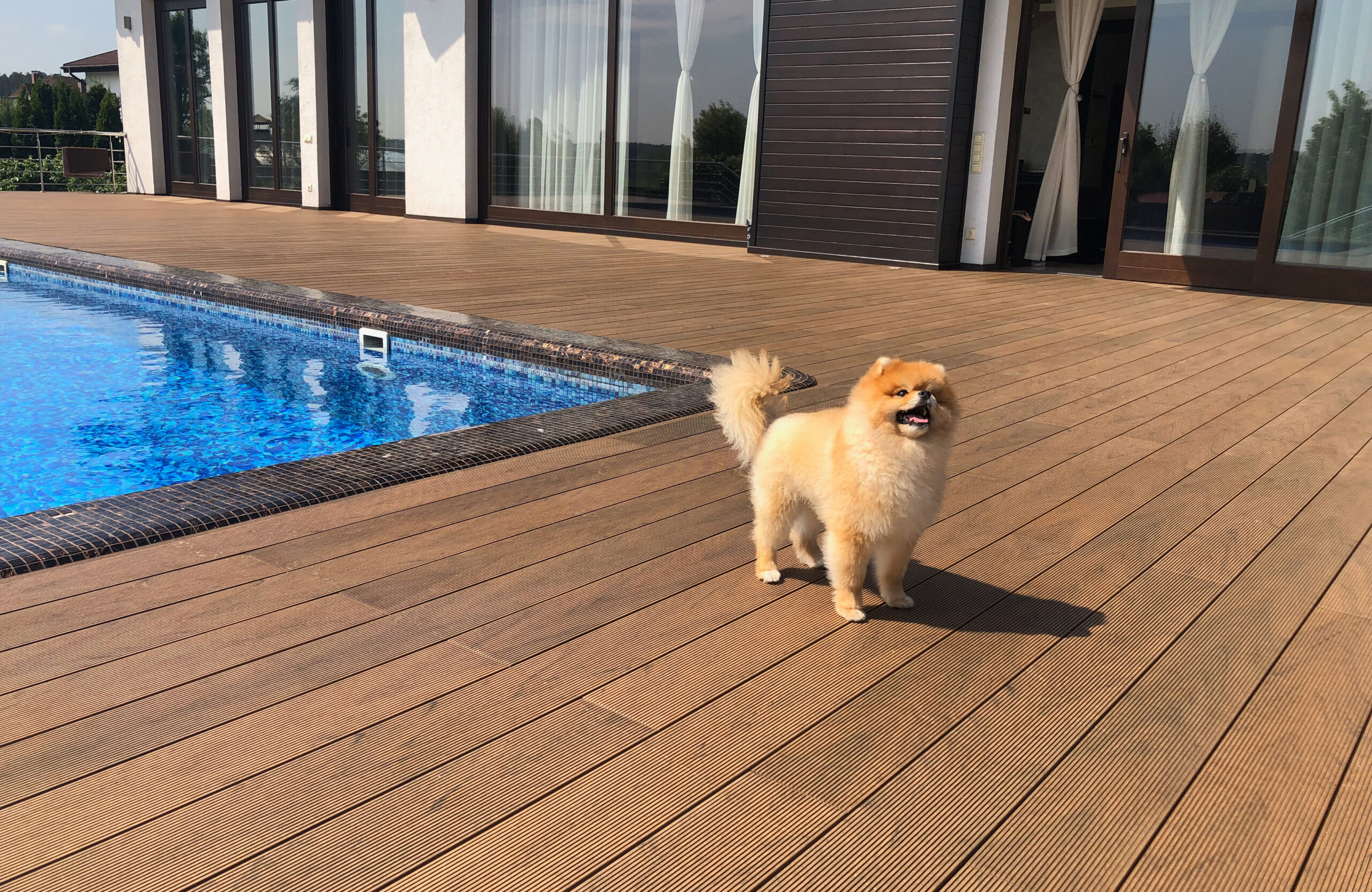 Bruggan Multicolor Cedar composite decking around a private outdoor swimming pool