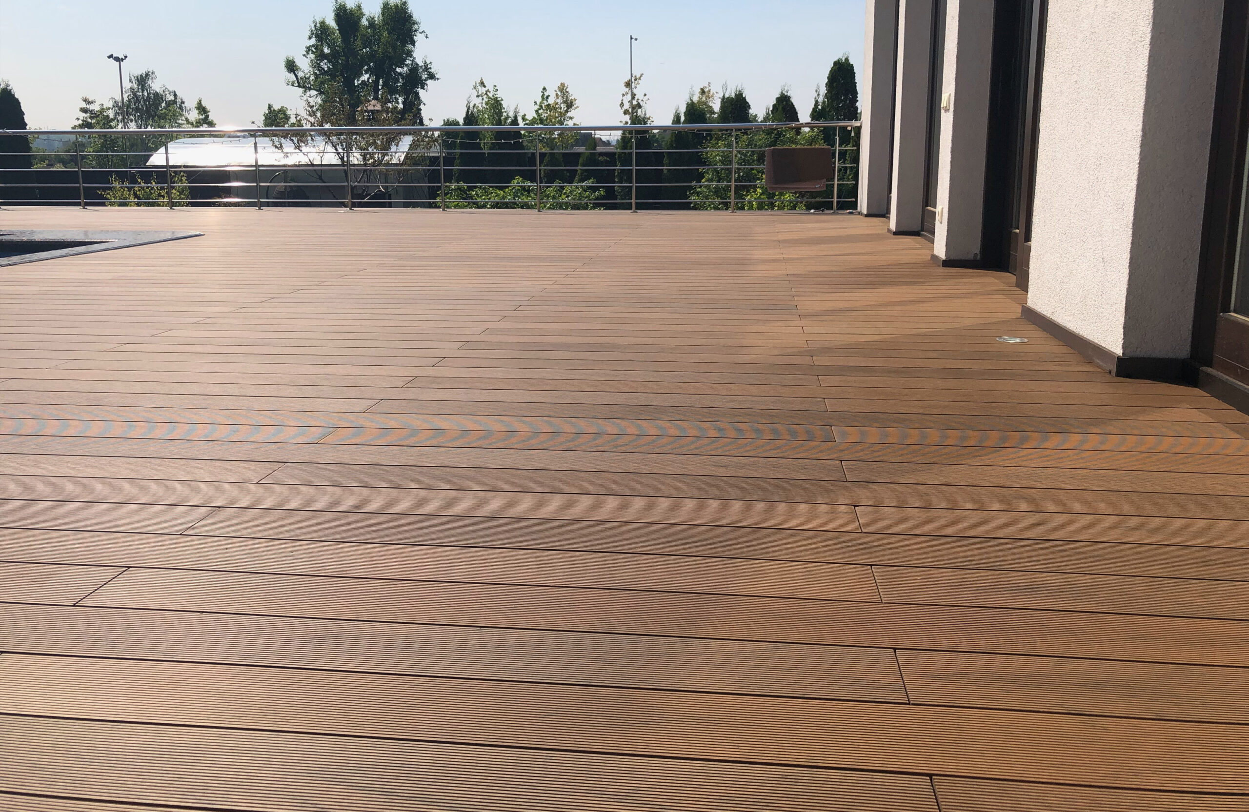 Bruggan Multicolor Cedar composite decking around a private outdoor swimming pool