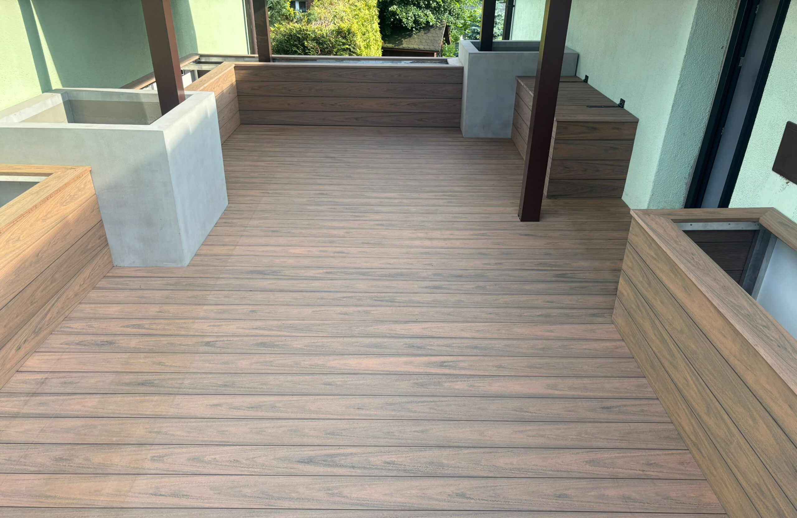 Bruggan Multicolor Cedar composite decking with matching wall cladding and outdoor storage