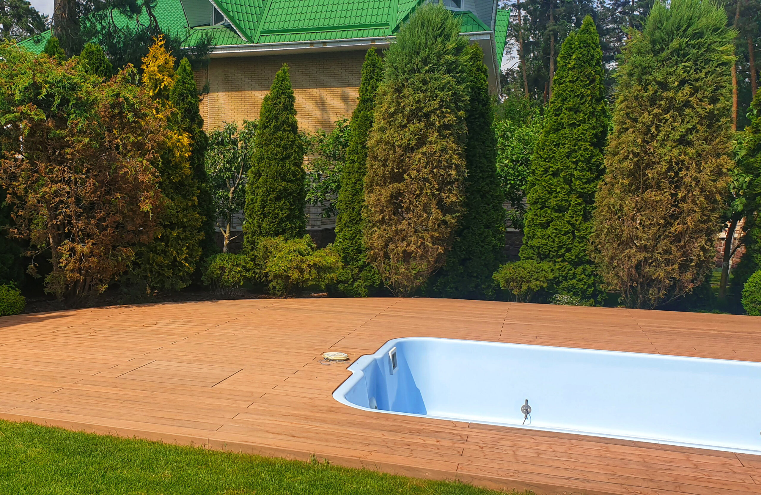 Bruggan Multicolor Cedar pool decking in a landscaped garden