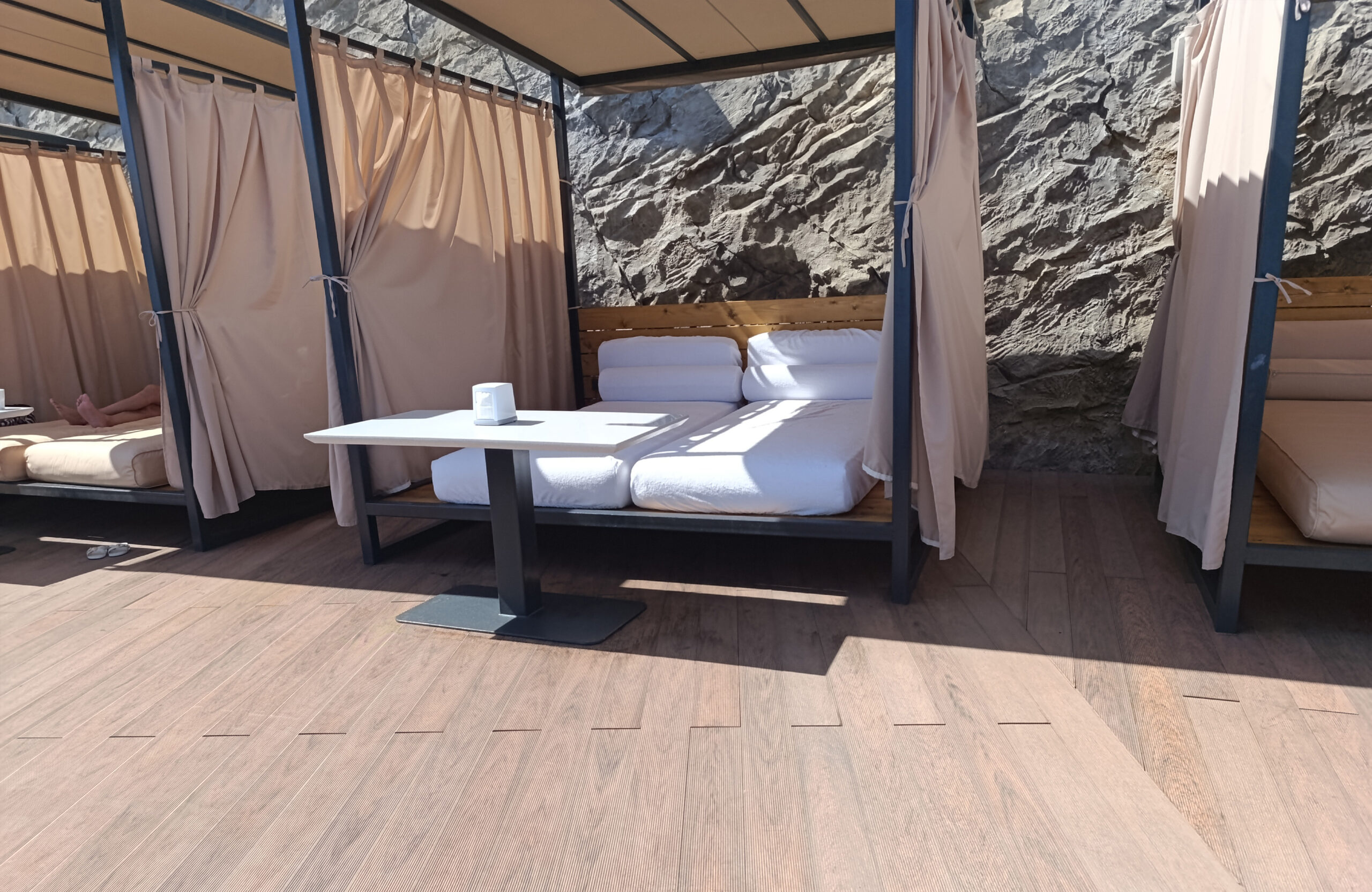 Bruggan Multicolor Cedar composite decking in a luxury outdoor lounge area with private cabanas