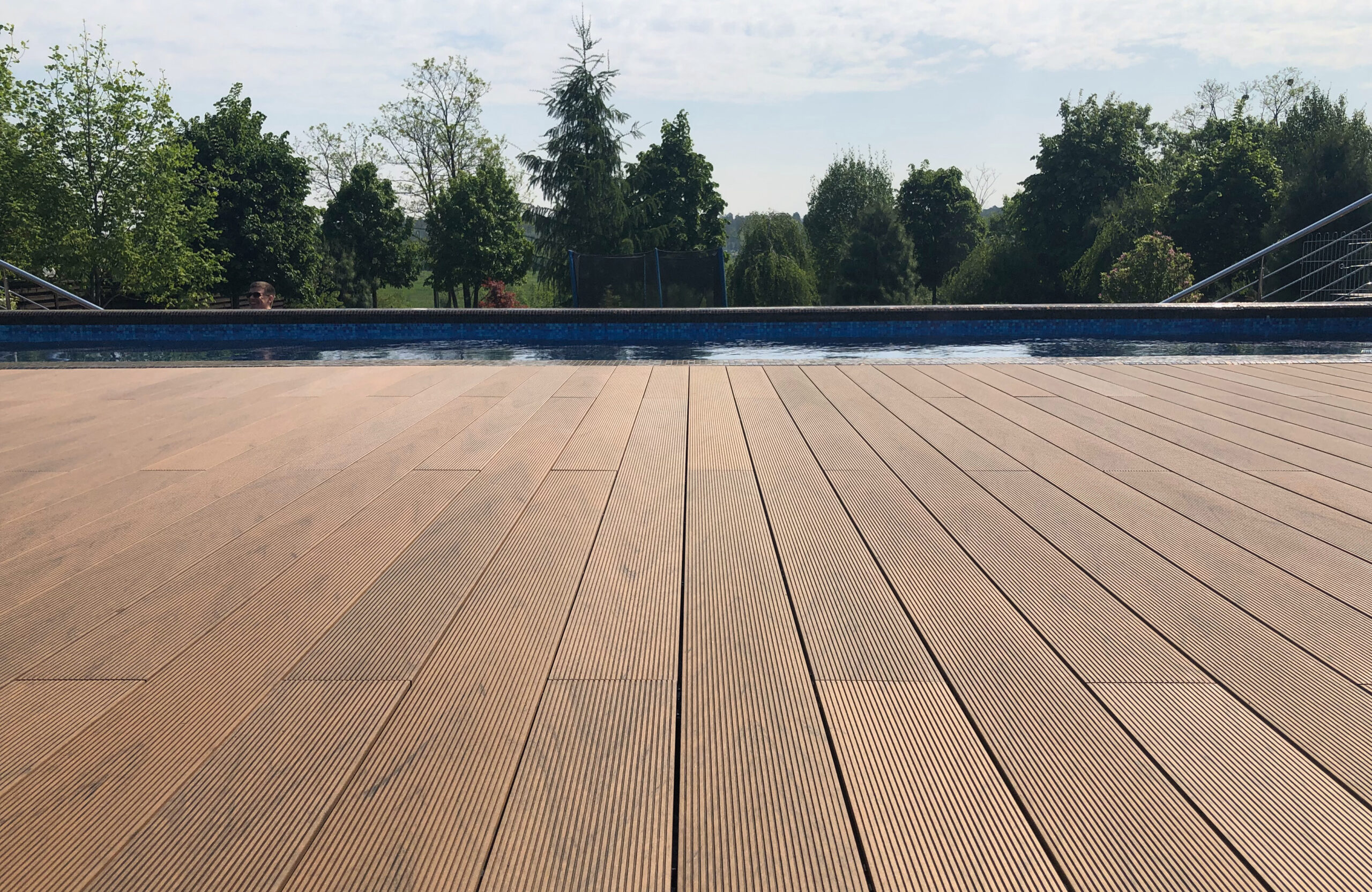 Bruggan Multicolor Cedar composite decking around a private outdoor swimming pool