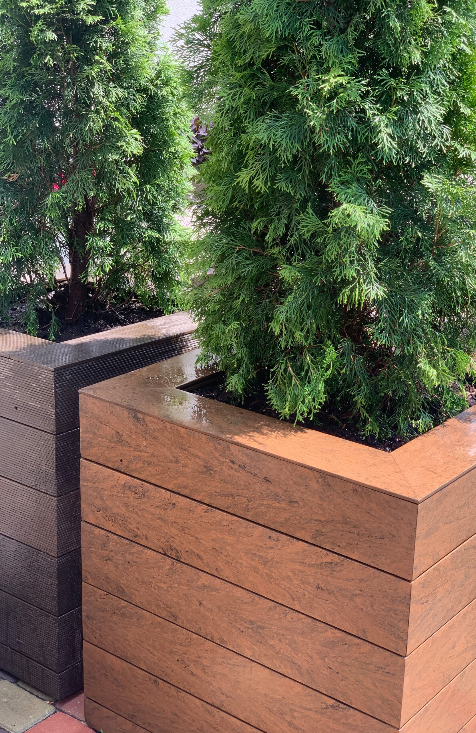 Garden planter clad with Bruggan Multicolor Cedar composite decking boards