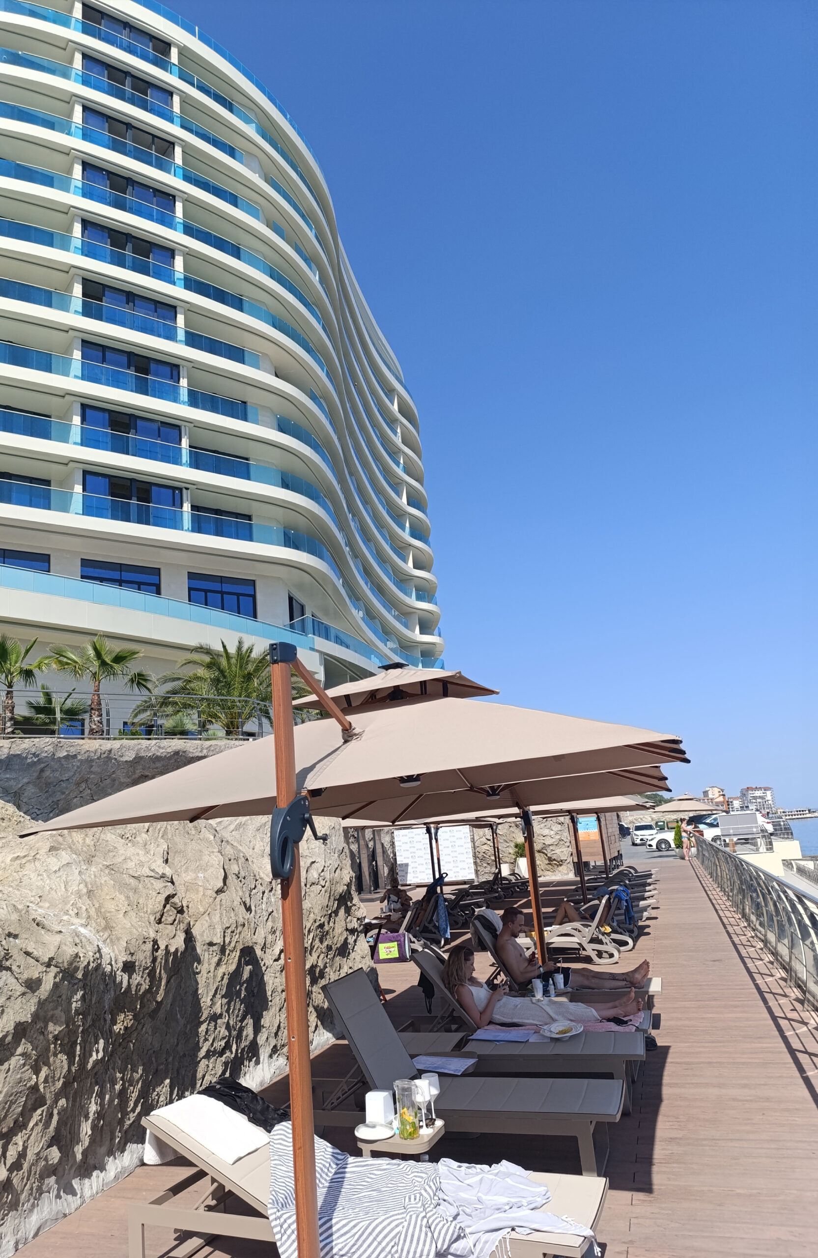 Seaside resort terrace with Bruggan Multicolor Cedar composite decking and sun loungers