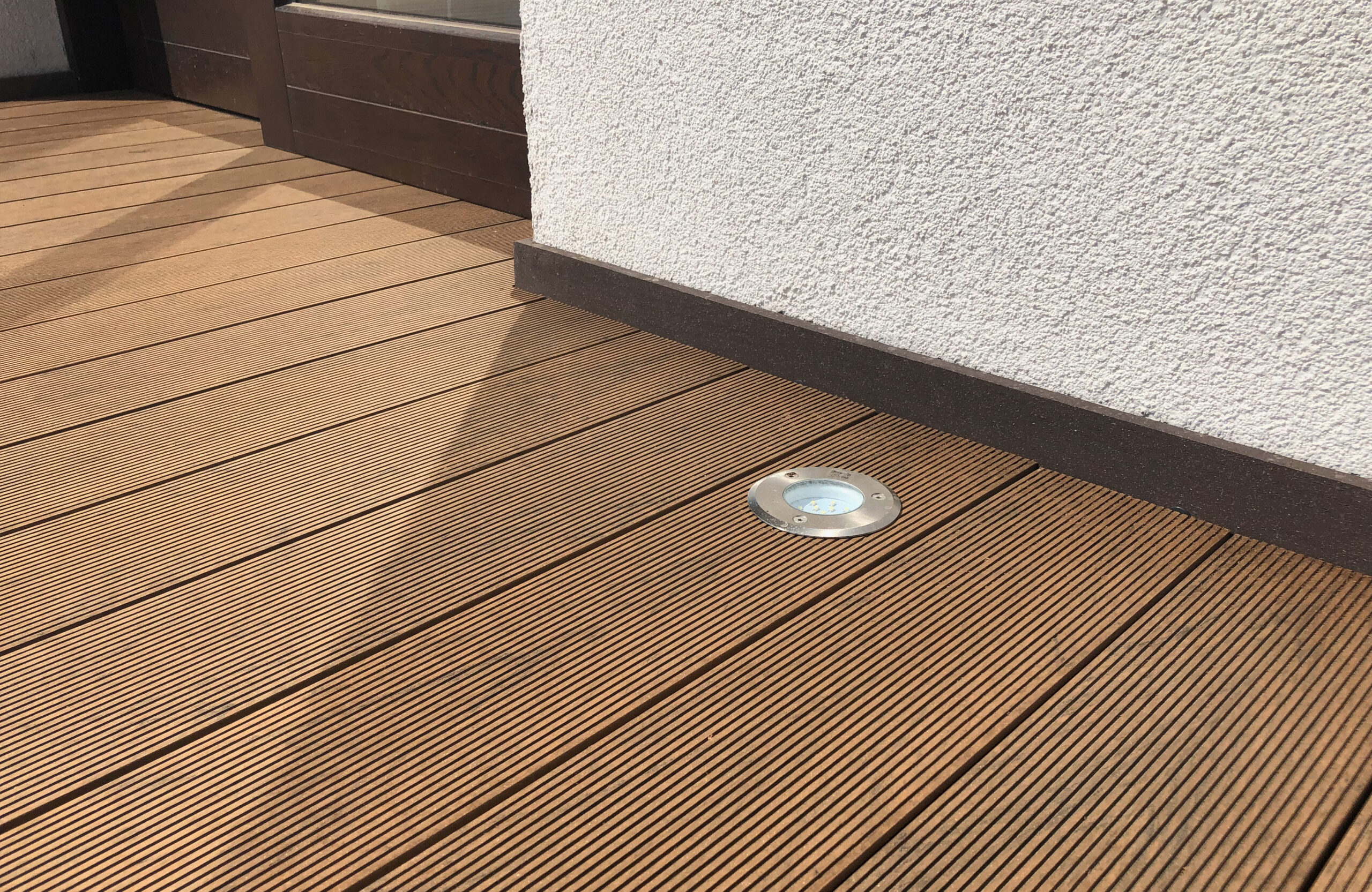 Bruggan Multicolor Cedar composite decking around a private outdoor swimming pool