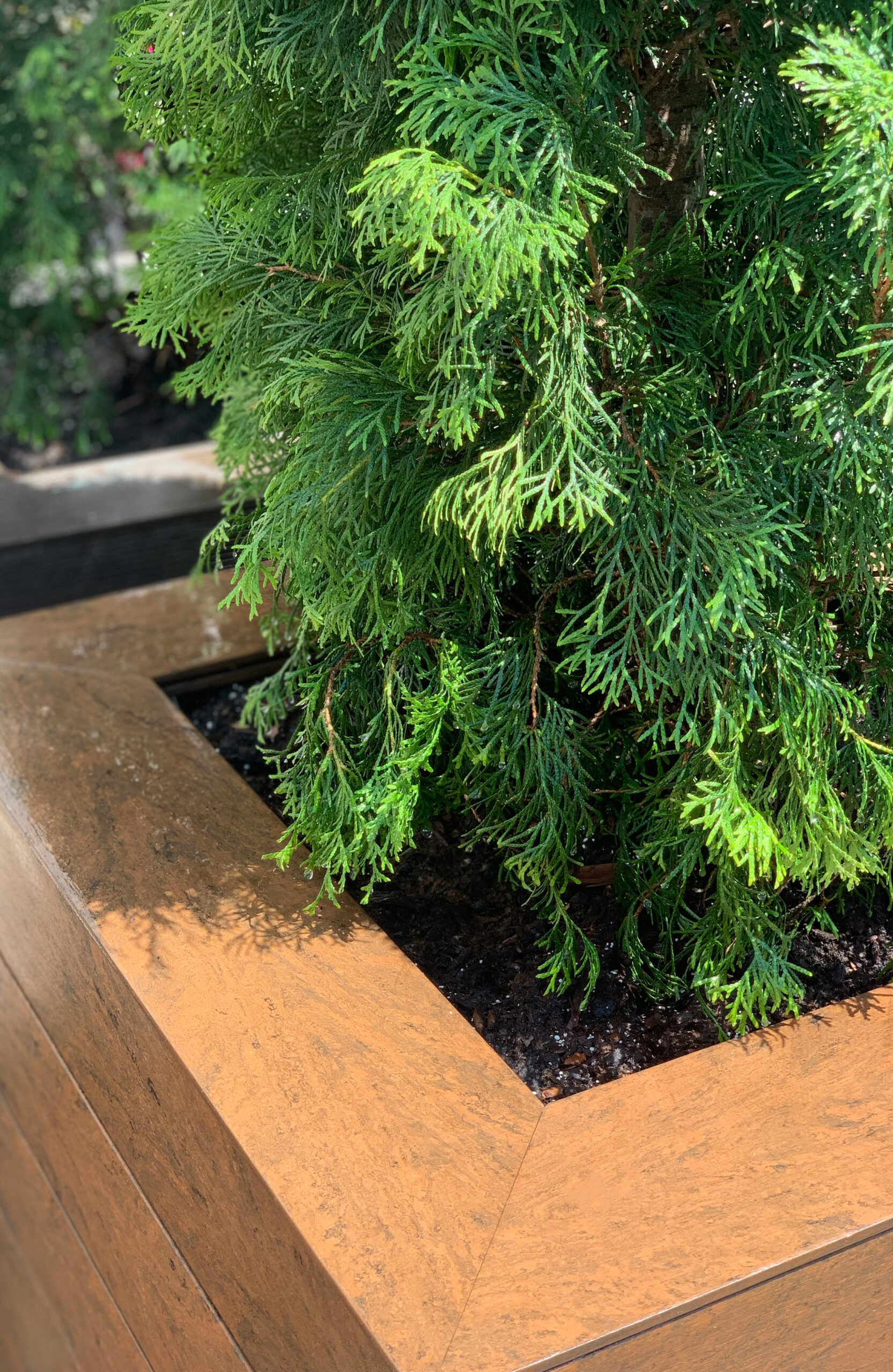 Garden planter clad with Bruggan Multicolor Cedar composite decking boards