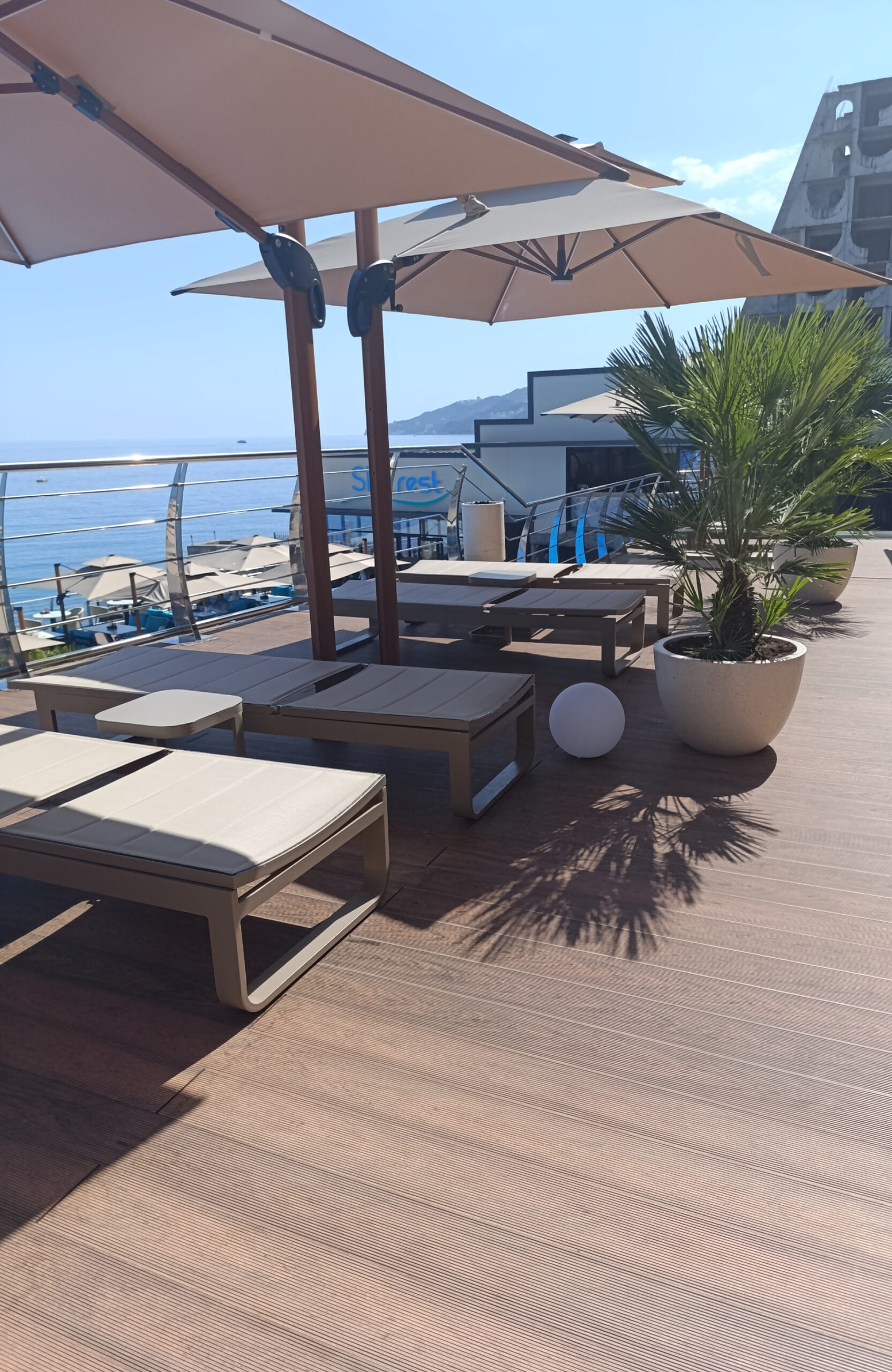 Bruggan Multicolor Cedar composite decking on a panoramic seaside terrace