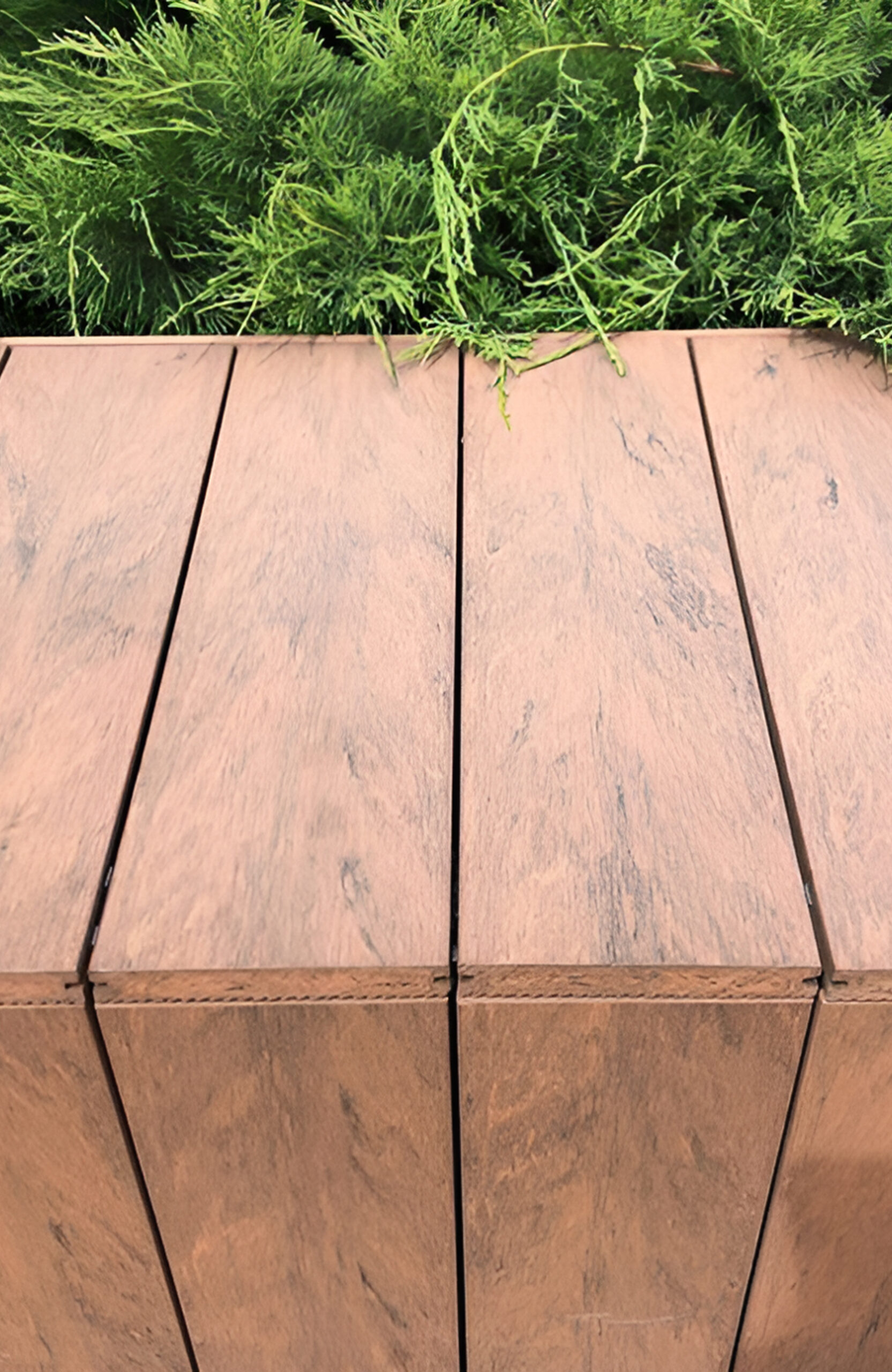 Bruggan Multicolor Cedar composite decking walkway through a landscaped garden