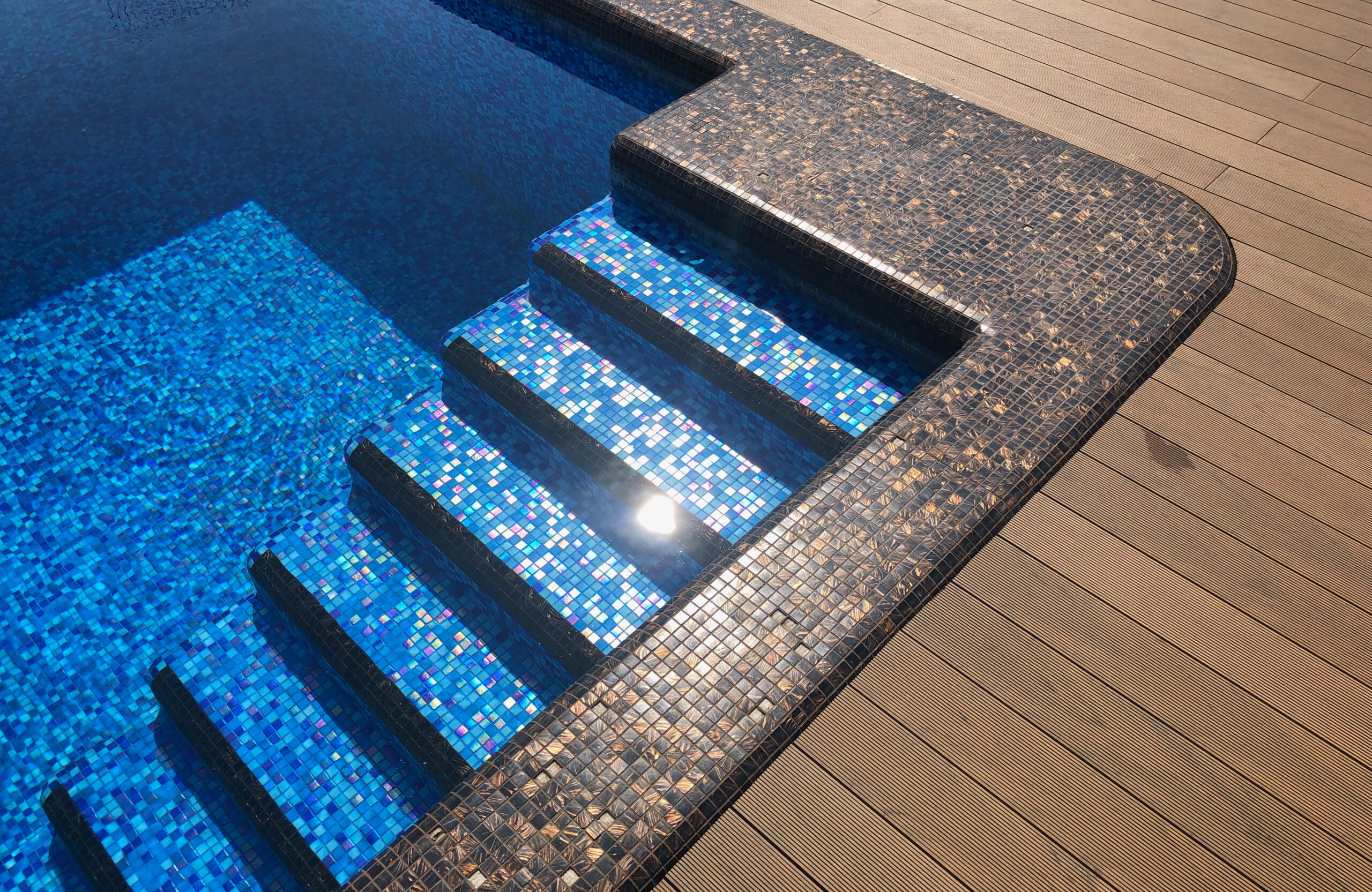 Bruggan Multicolor Cedar composite decking around a private outdoor swimming pool