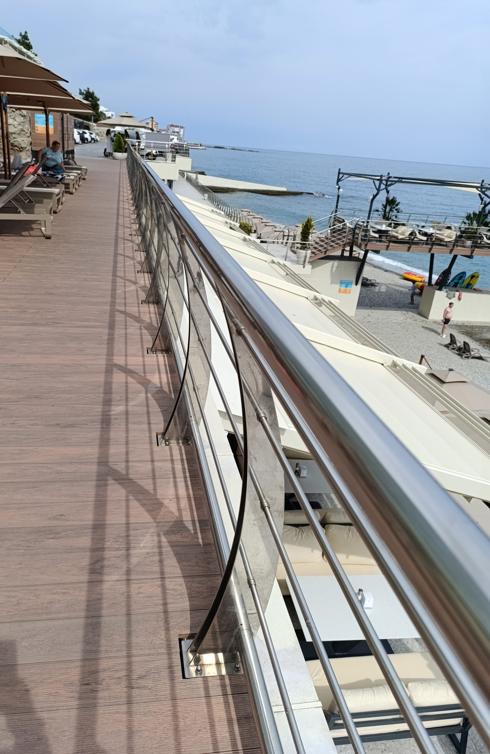 Bruggan Multicolor Cedar composite decking walkway overlooking the sea and beach