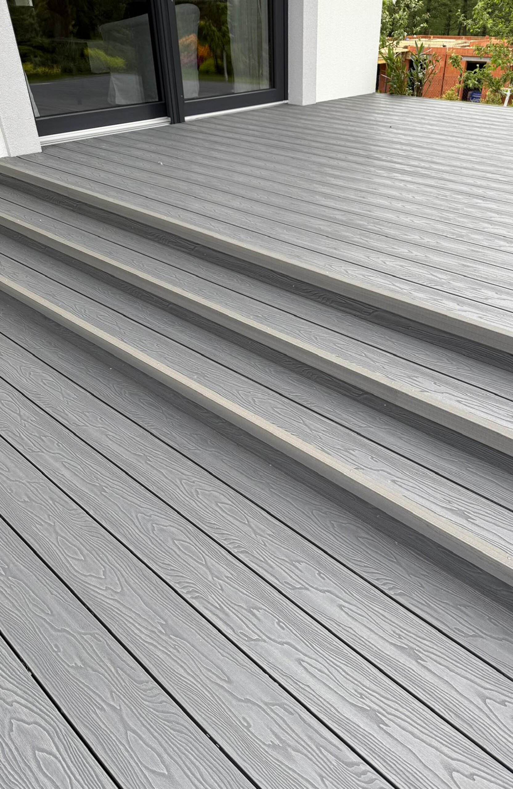 Bruggan Elegant Graphite composite decking and matching outdoor steps with wood grain finish