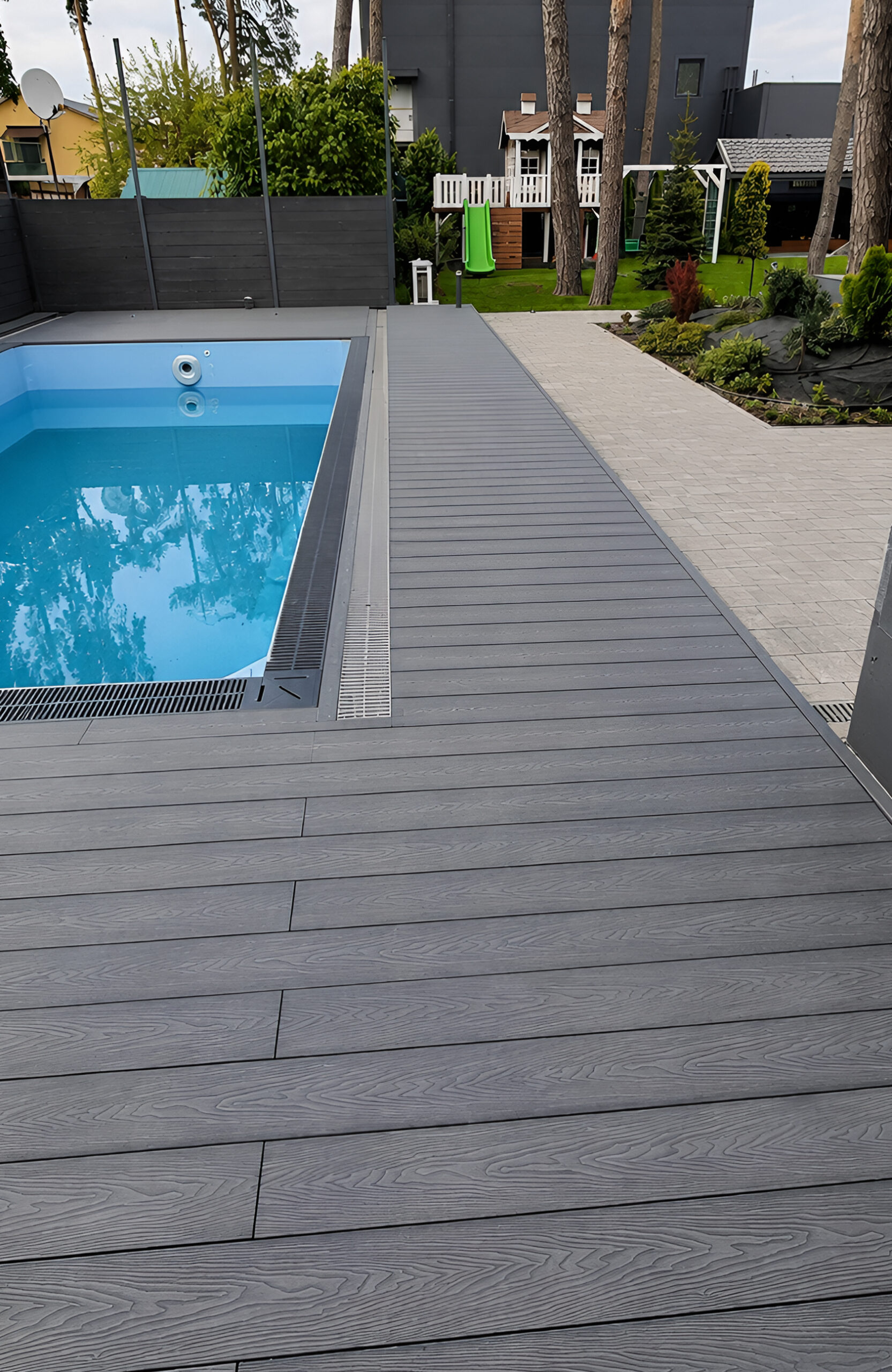 Close-up of Bruggan Elegant Graphite decking installed around a residential swimming pool