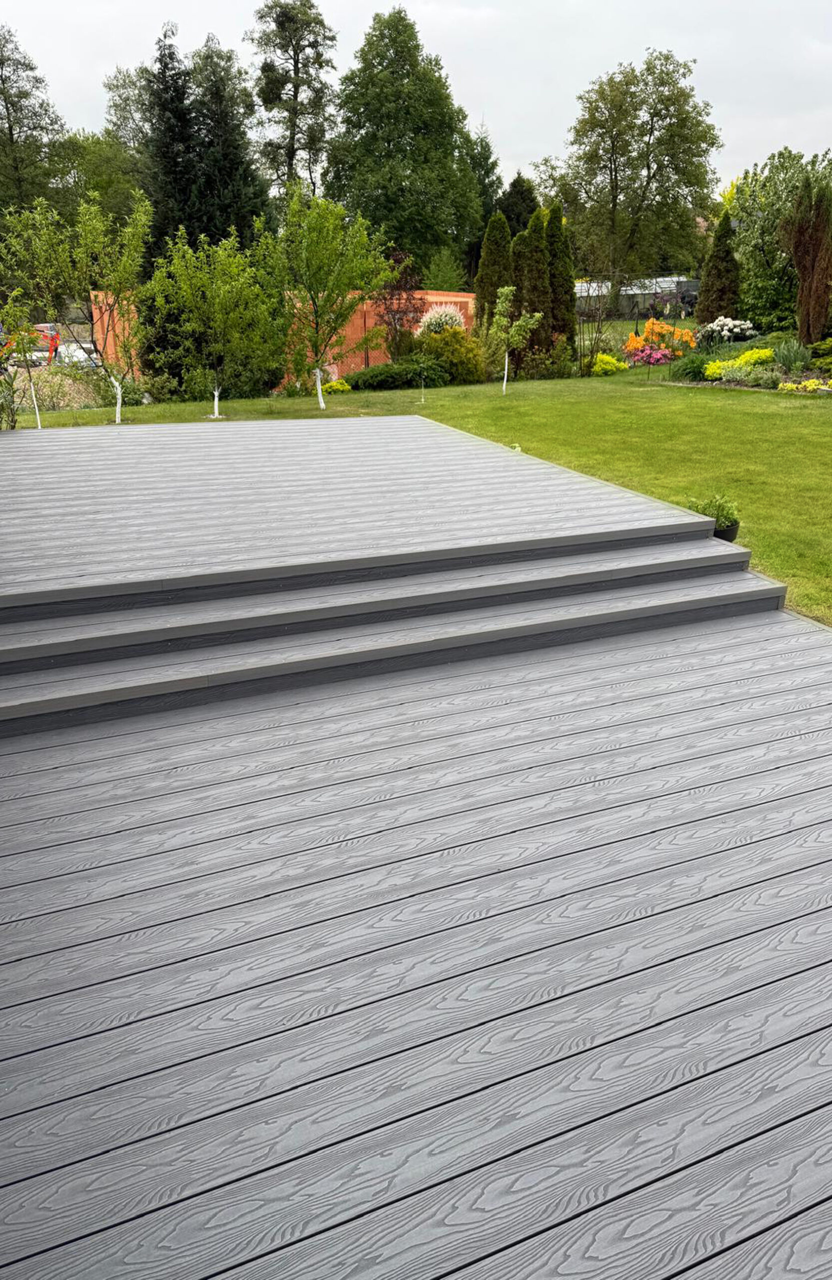 Bruggan Elegant Graphite decking terrace with wide steps and landscaped garden