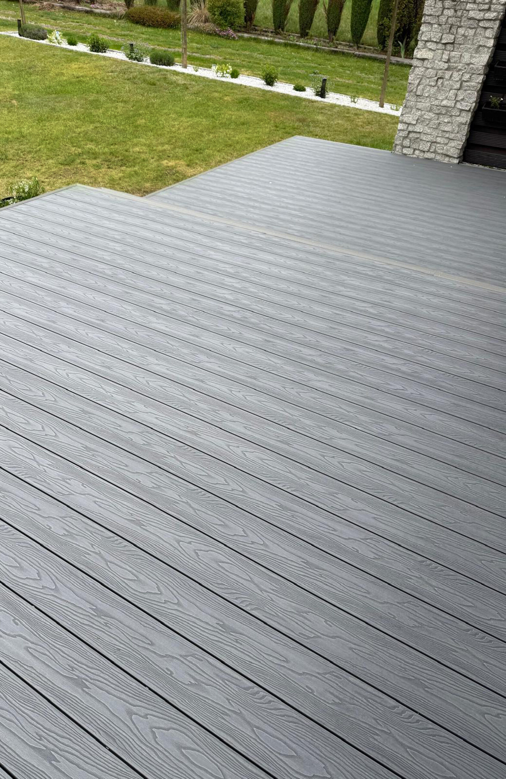 Close view of Bruggan Elegant Graphite composite decking with natural wood grain pattern