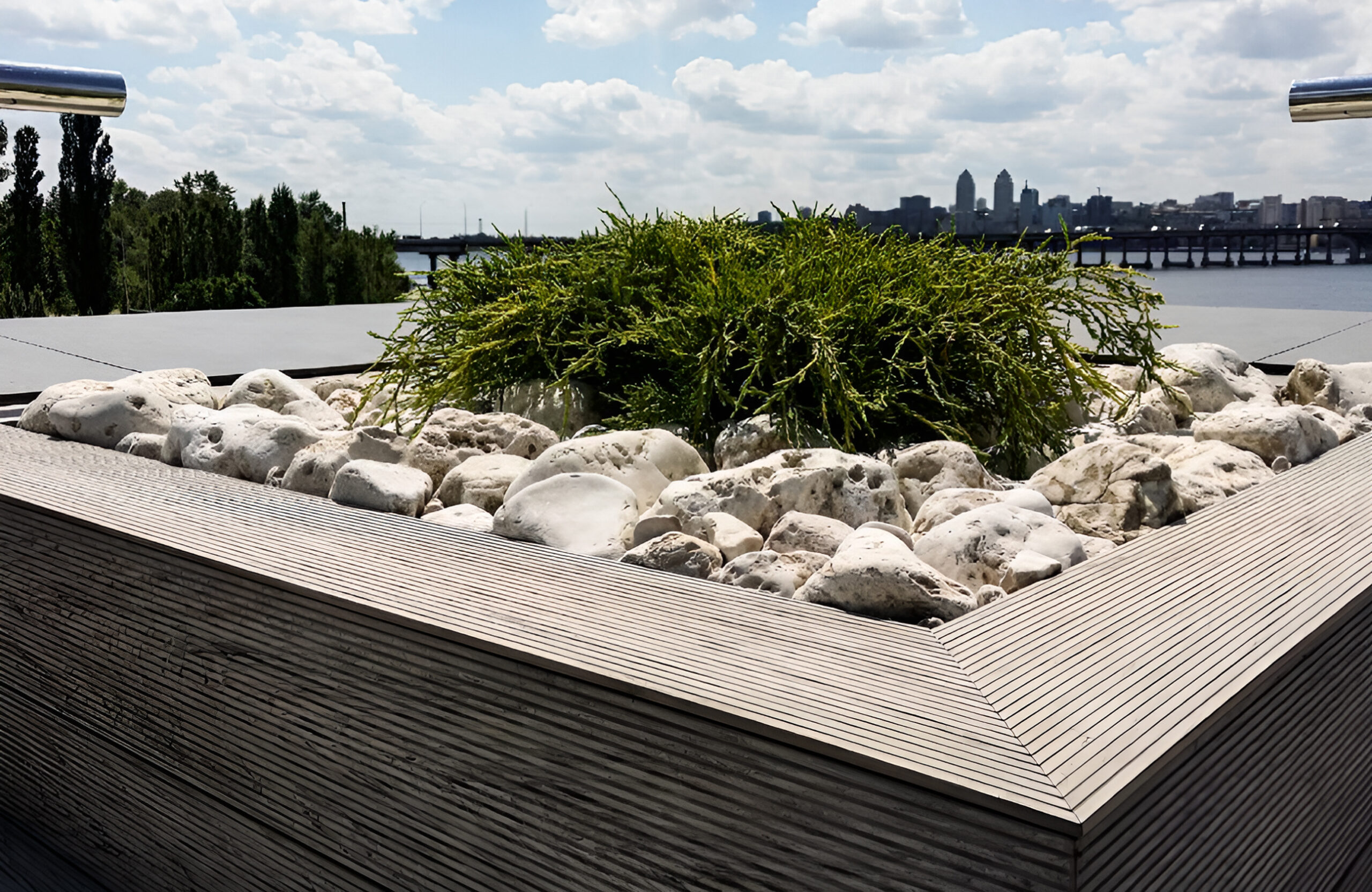Stylish urban rooftop terrace featuring BRUGGAN Multicolor grey composite decking and modern outdoor design