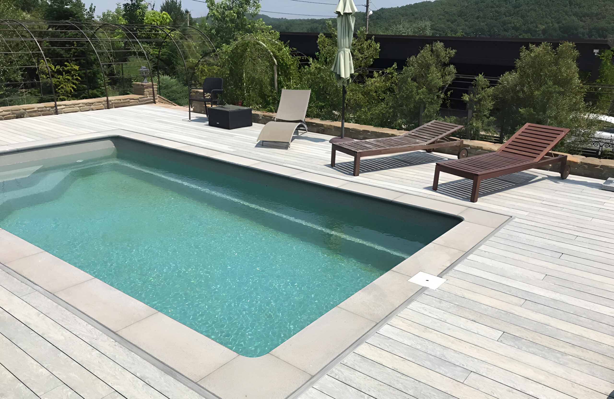Grey BRUGGAN Multicolor decking for a stylish outdoor pool area