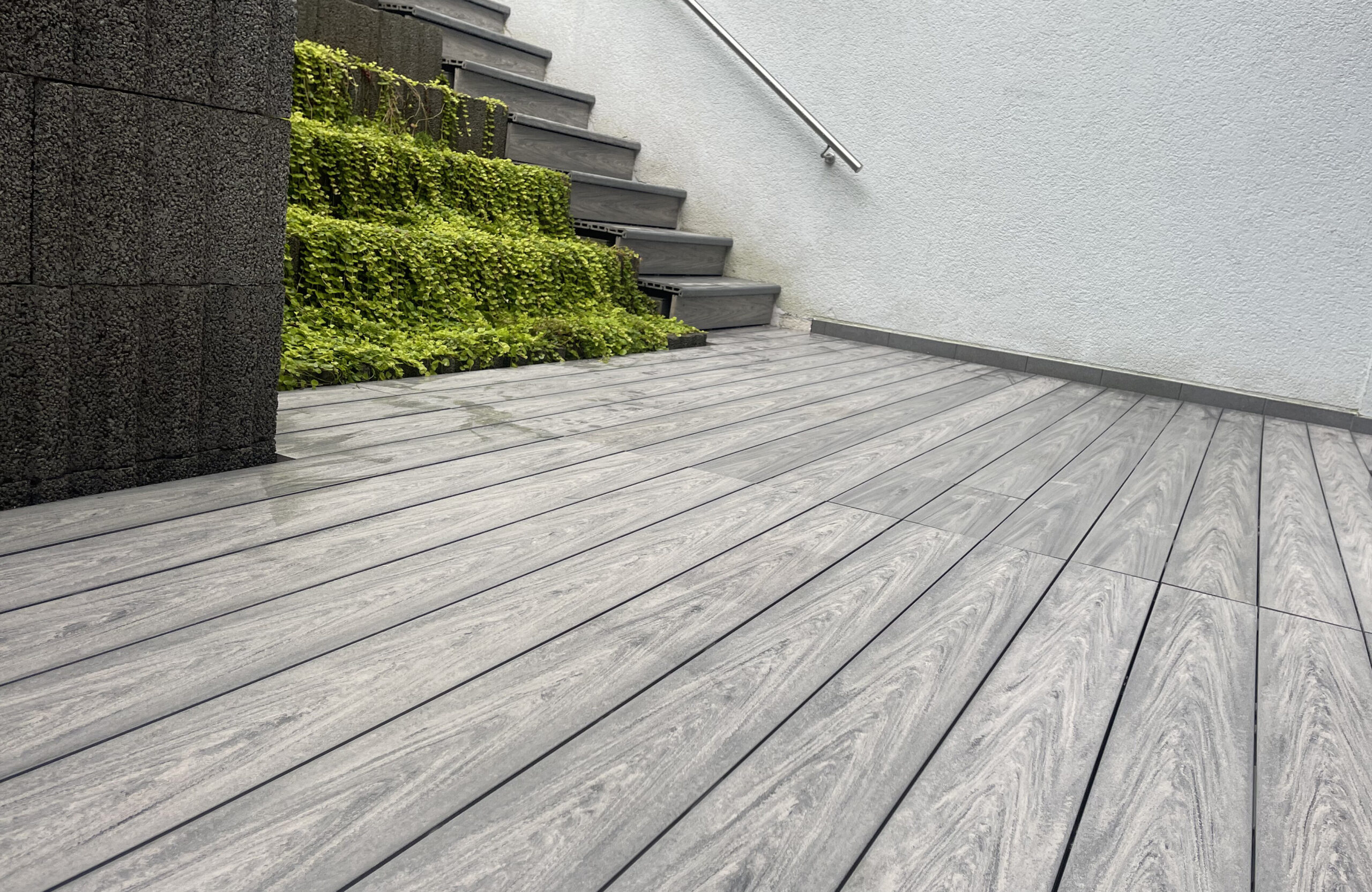 BRUGGAN MultiColor Grey composite decking and stairs in a modern landscaped residential terrace